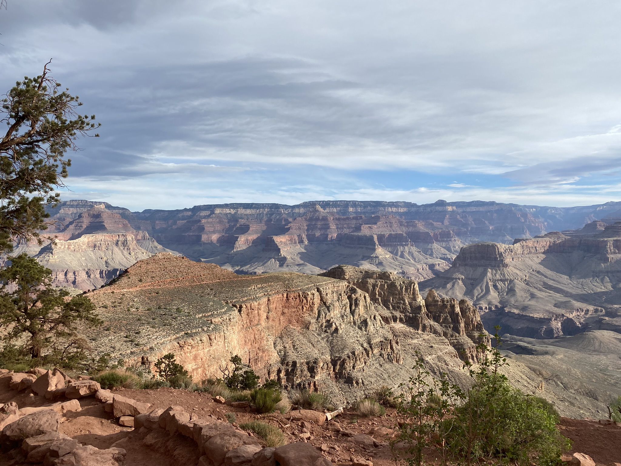 Expansive view of a vast, layered canyon under a cloudy sky. - Skeleton Point – Cedar Ridge loop from Clear Creek Backcountry Use Cairns