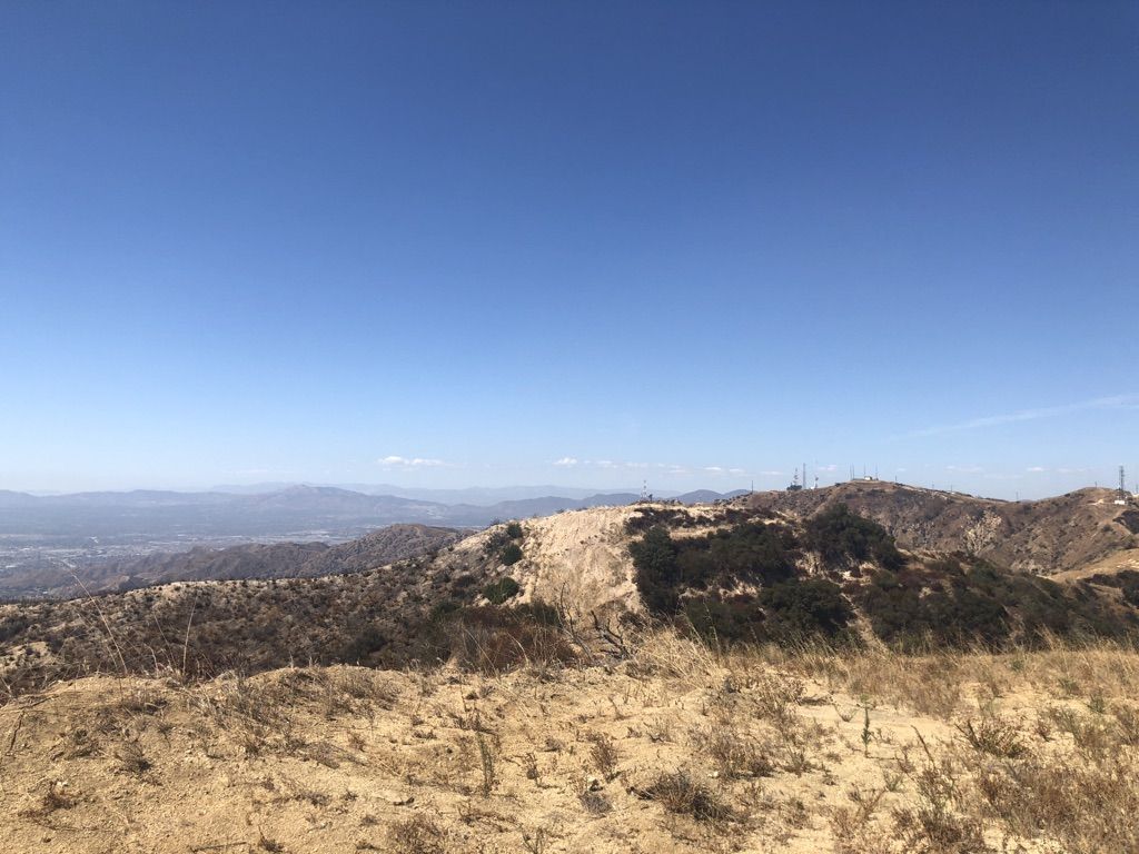 Vast, dry mountain landscape with distant peaks under a bright blue sky. - Verdugo Peak via Skyline Motorway