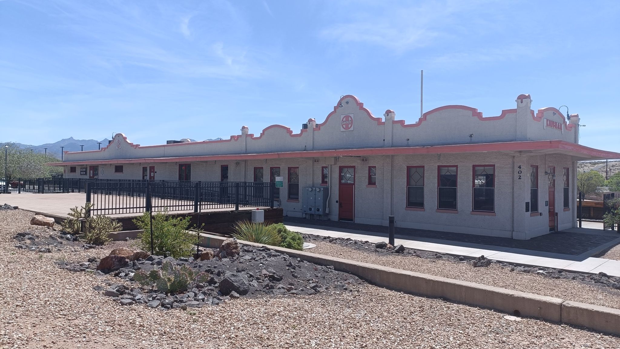 A long, light-colored building with red trim under a clear blue sky. - Kingman to Hualapai Mountain Park
