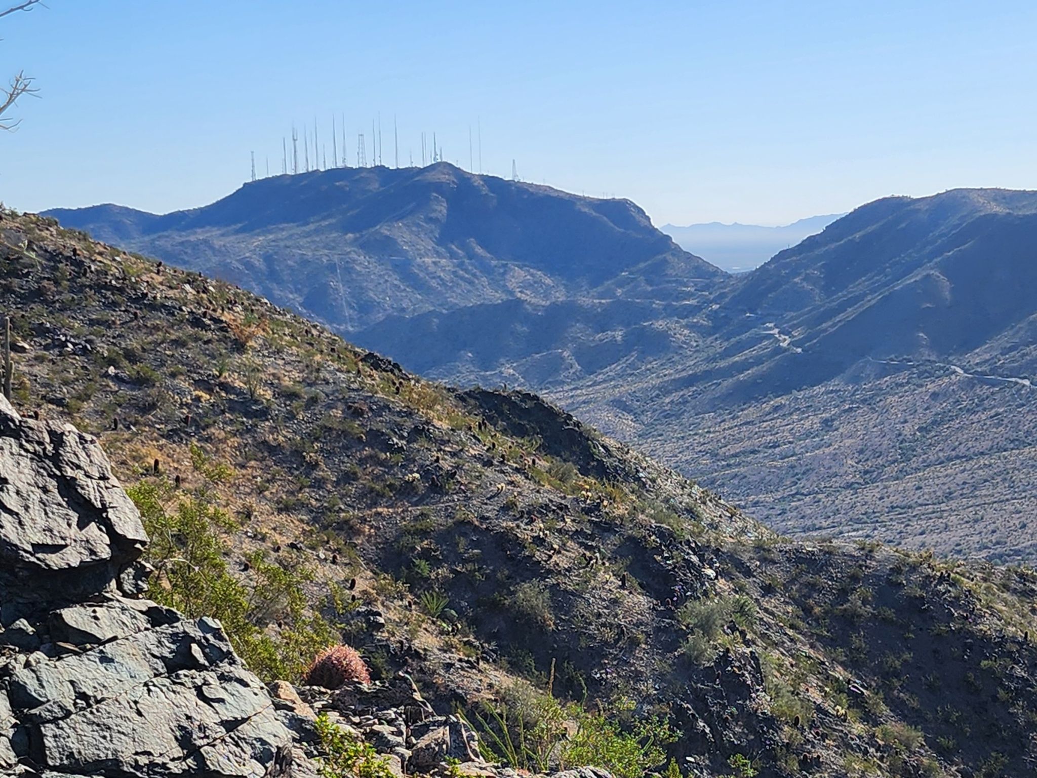 Rugged desert mountains and a deep valley under a clear blue sky. - Hau'pal Loop Trail