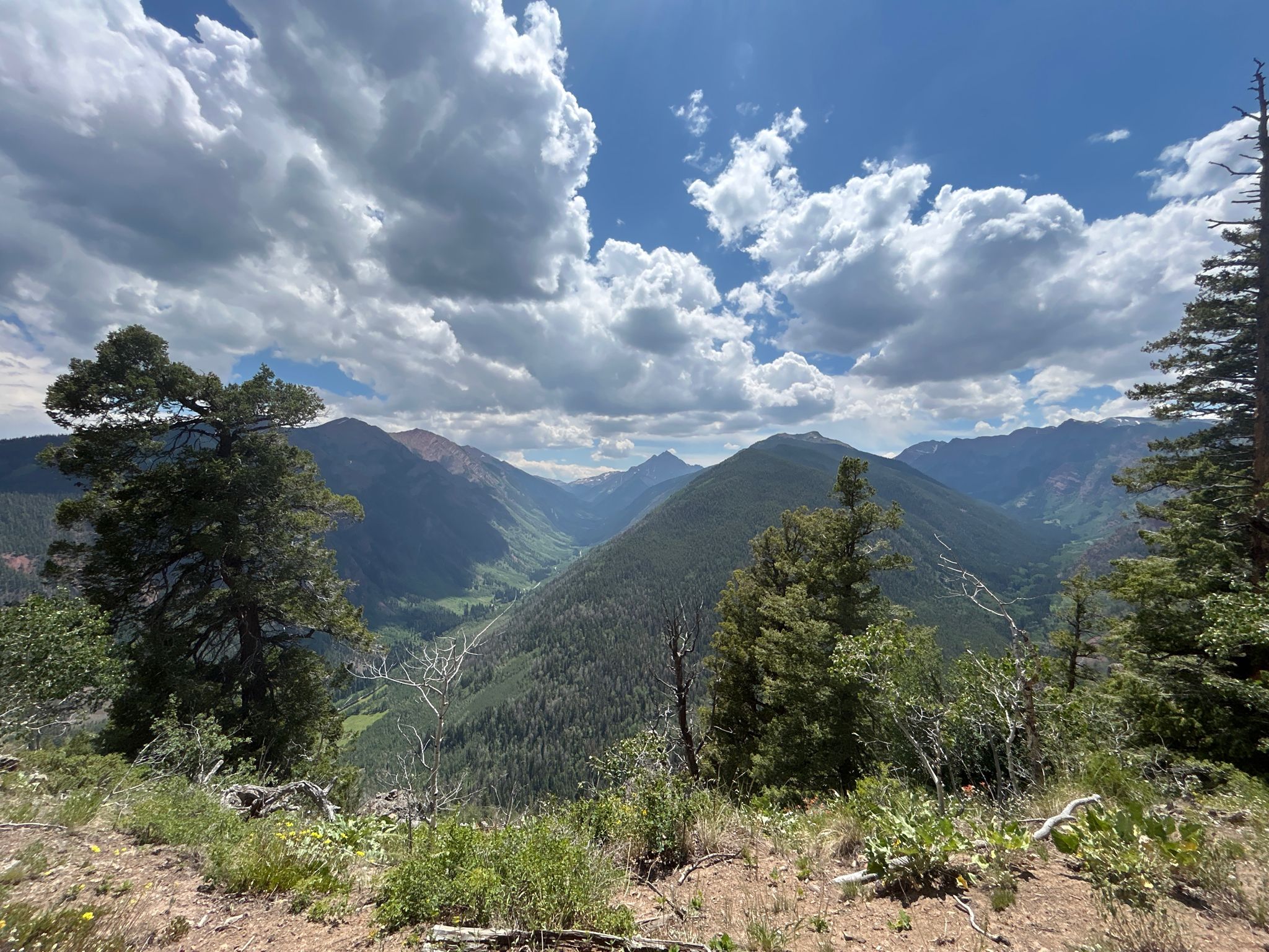 Wide view of forested mountains and a valley under a dramatic cloudy sky. - Government Trail and Buttermilk Mountain Loop