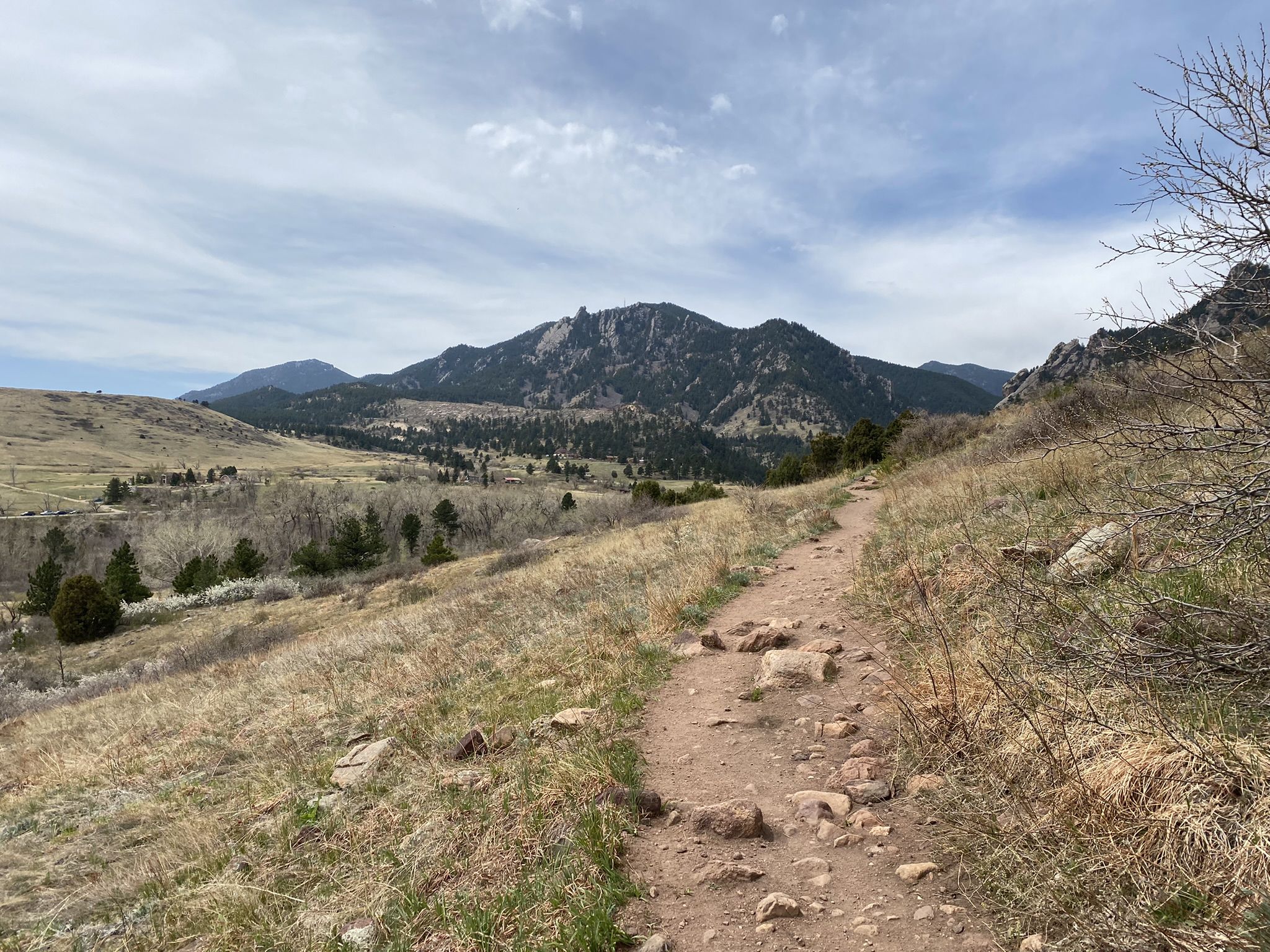 A winding dirt trail through dry hills and distant mountains under a cloudy sky. - Upper Big Bluestern Trail loop from Eldorado Springs