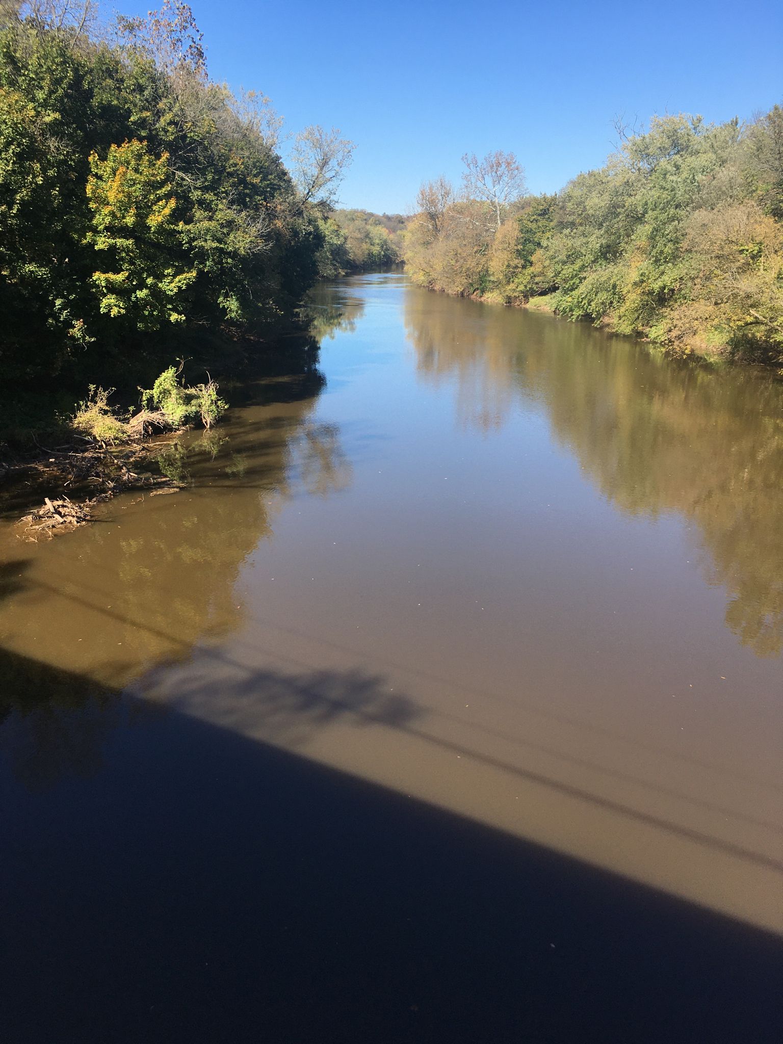 A wide river flows between wooded banks under a clear blue sky. - Rockford Road – Lancaster County Central Park loop from Lancaster