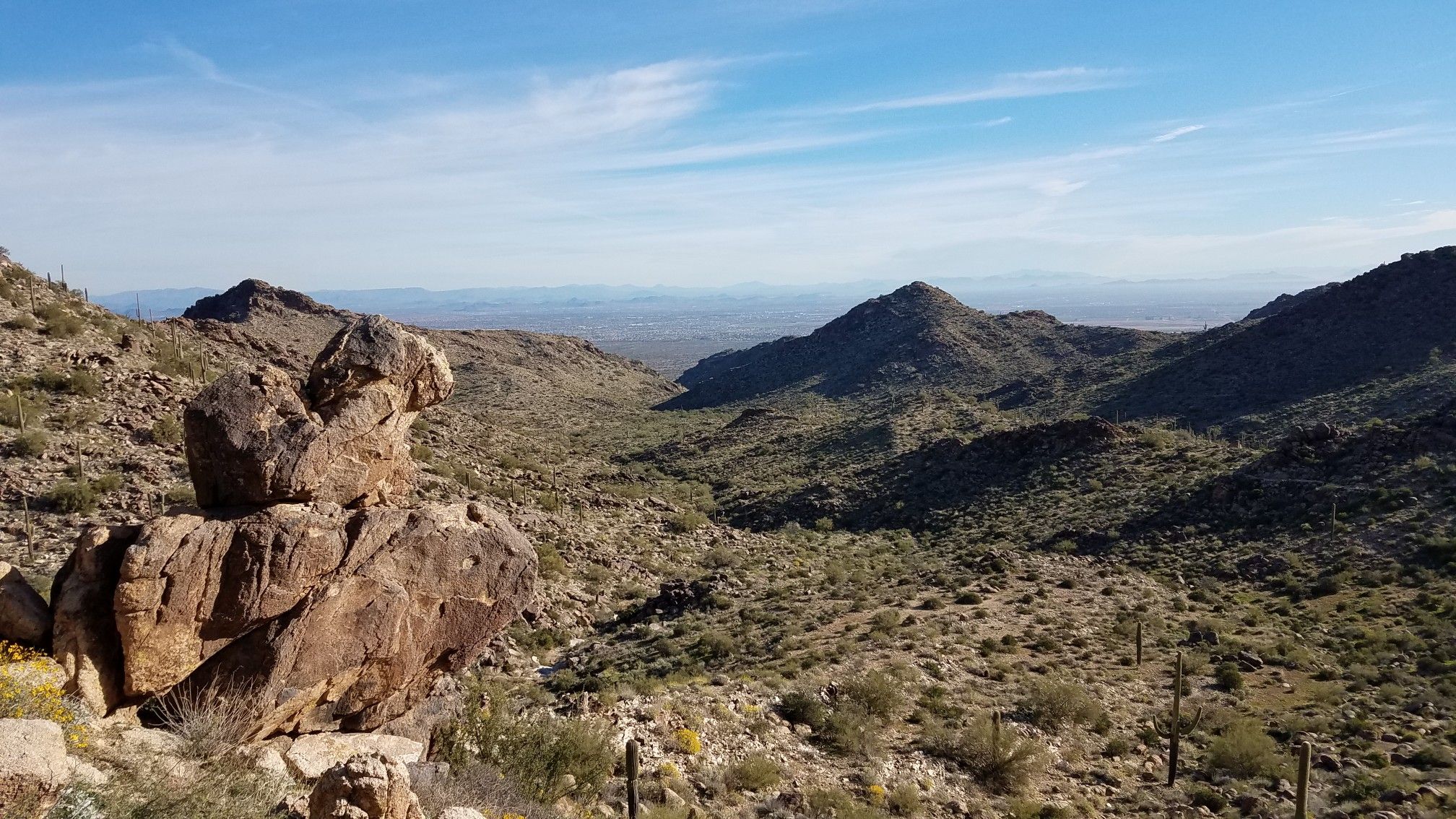 Rocky desert landscape with mountains and a valley under a blue sky. - Ford Canyon Loop Trail