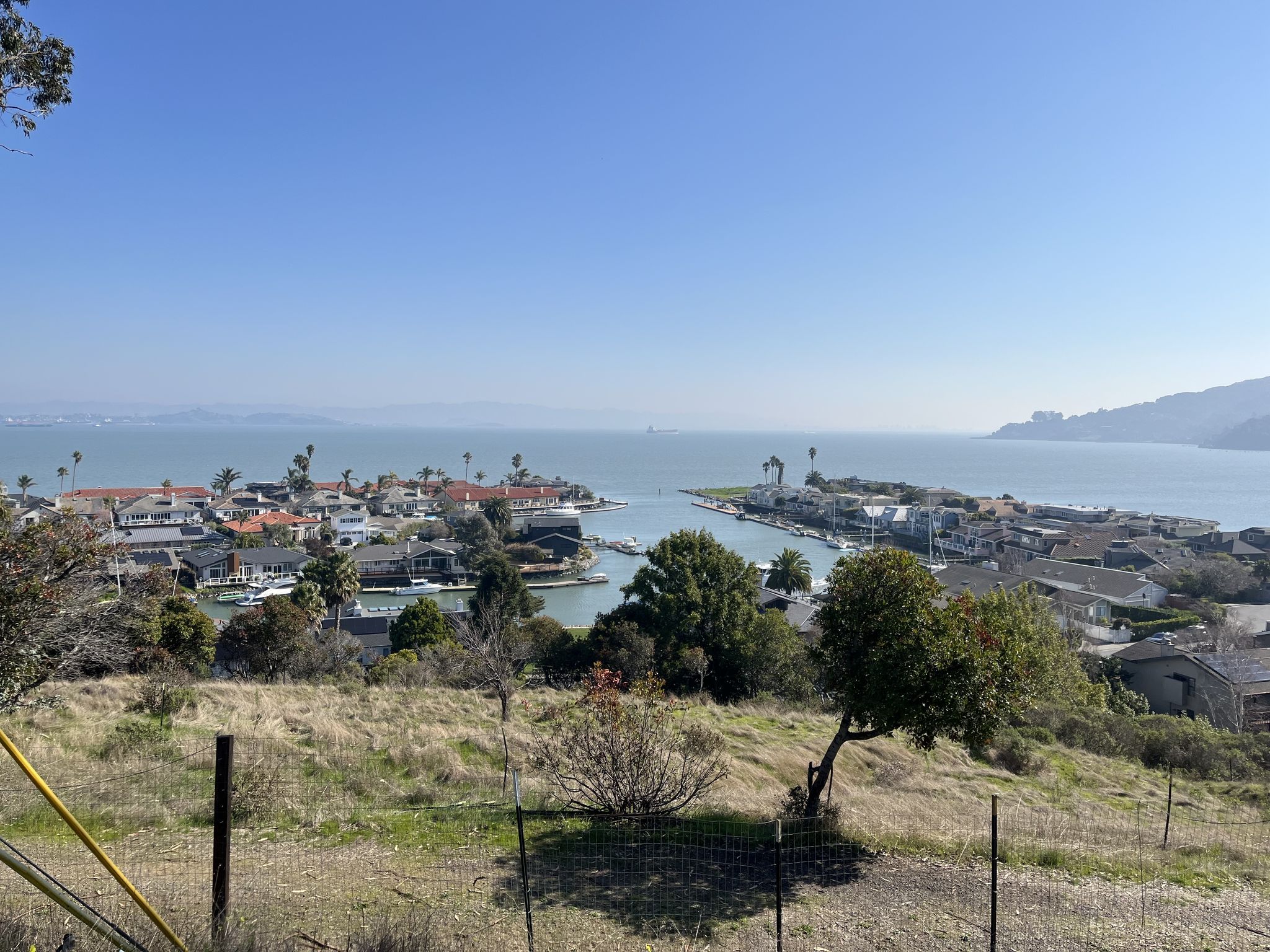 Elevated view of a coastal town with houses, canals, and wide water. - Camino Alto Road loop from Paradise Cay