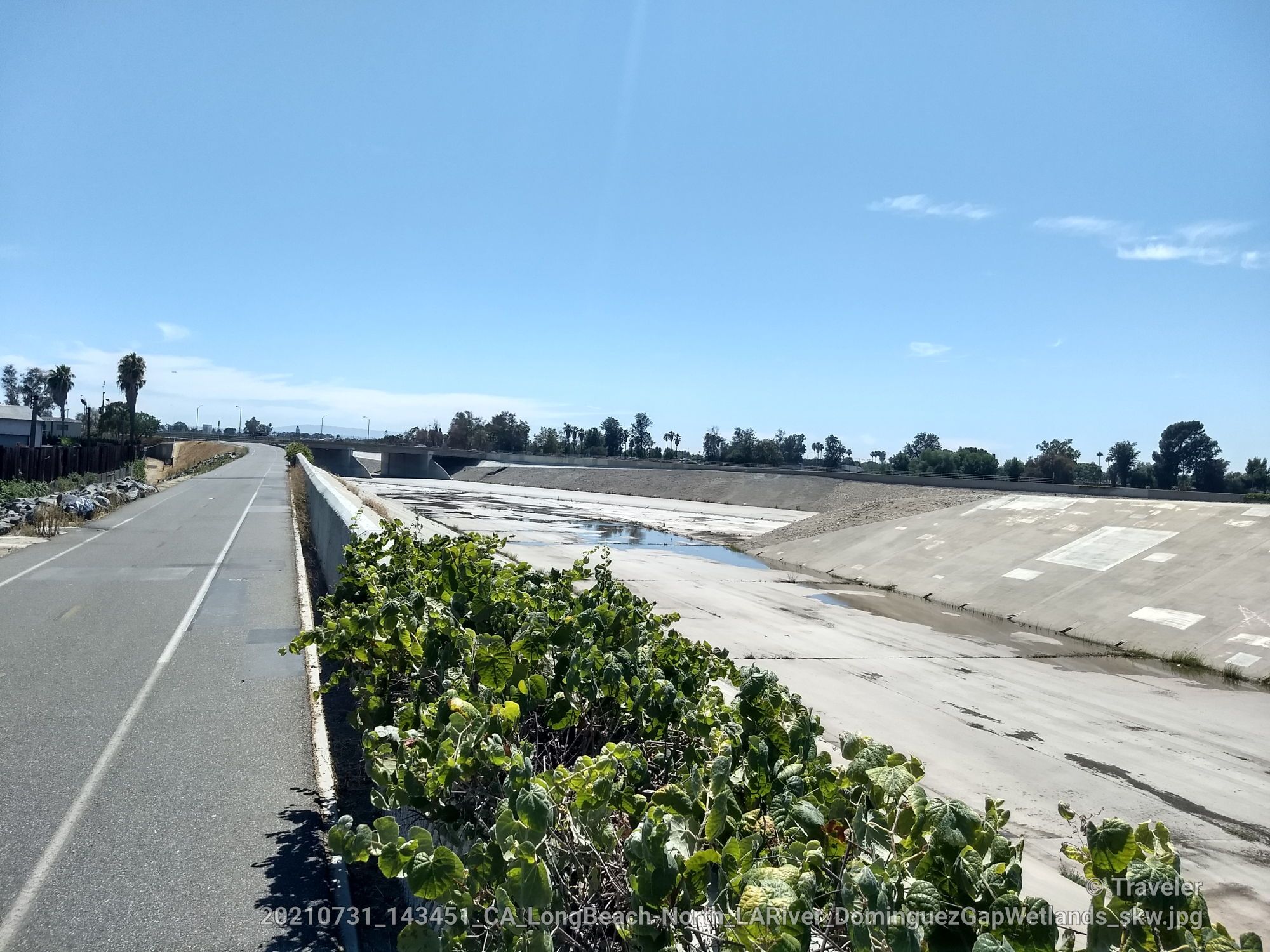 Paved road next to a wide, dry concrete channel under clear sky. - Rio Hondo Bike Bridge – Bosque del Rio Hondo loop from Lynwood
