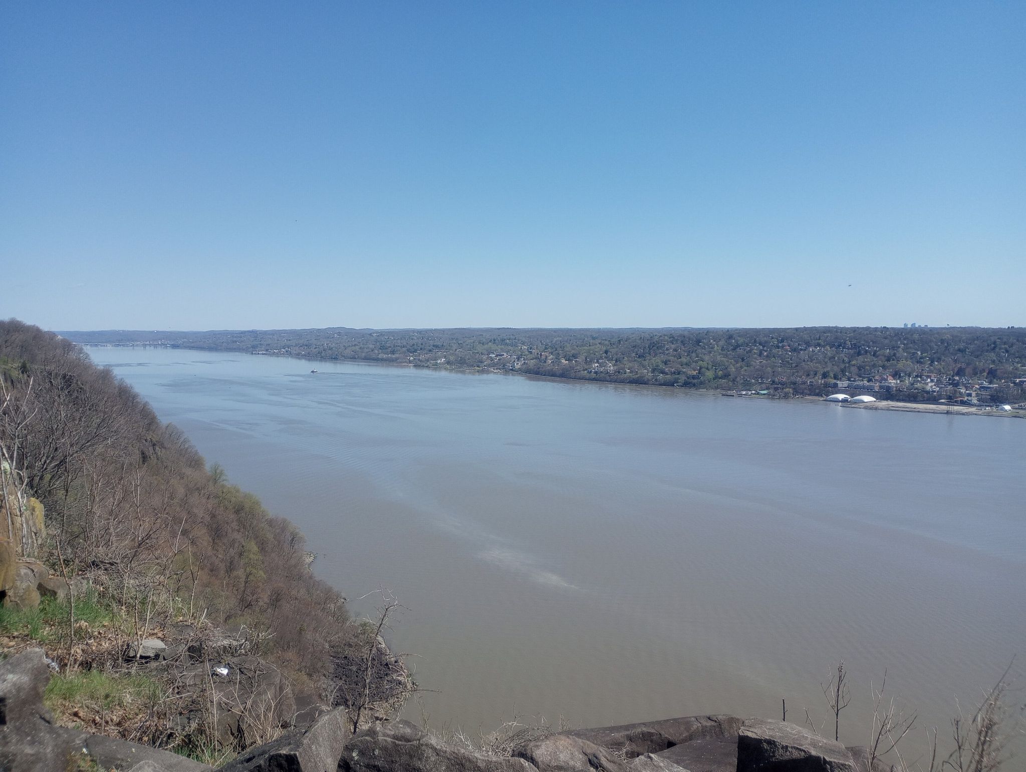 Wide river flowing between forested banks under a clear blue sky. - Excelsior Picnic Area – Long Path loop from Alpine