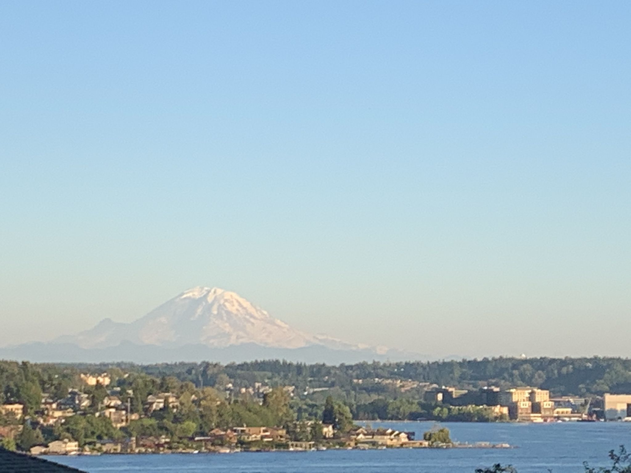 Majestic snow-capped mountain overlooking a body of water and shoreline. - East Mercer Way – Mercer Island loop from Mercer Island