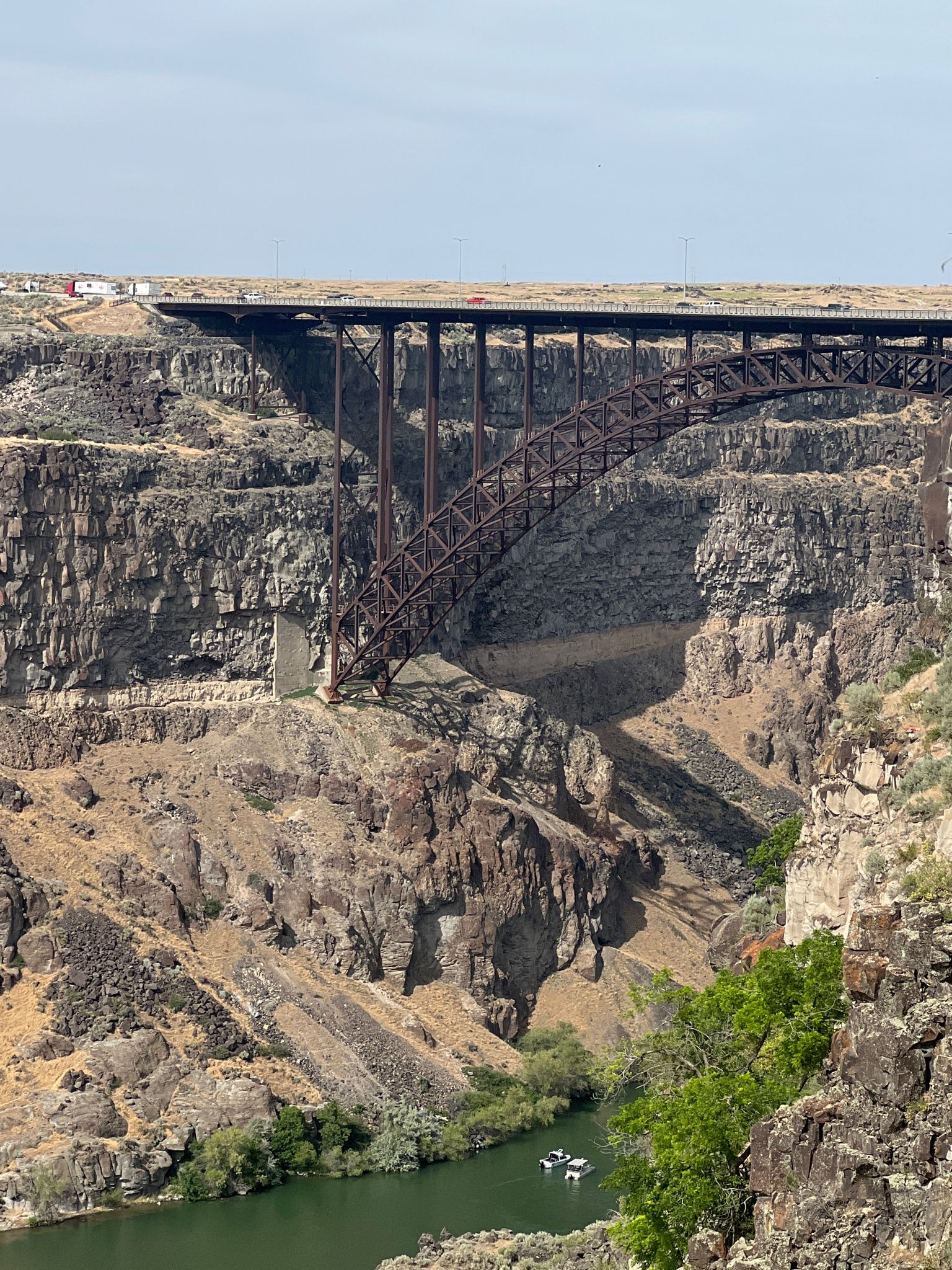 Tall steel arch bridge over a deep canyon with a green river below. - Snake River - Canyon Rim Trail – Morgensen Trailhead loop from Evergreen Building