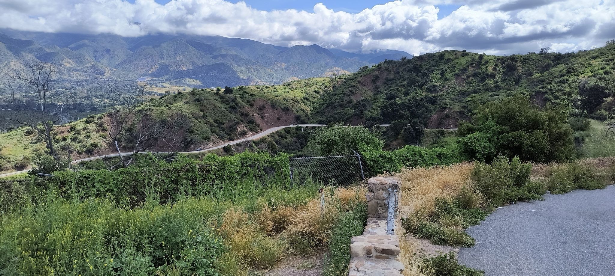 Winding road through lush green mountains under a cloudy sky. - Ventura - Santa Paula - Ojai Loop