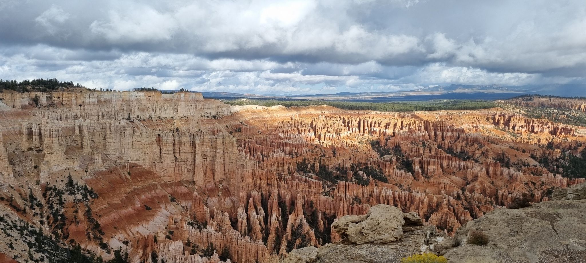 Panoramic view of sunlit and shadowed orange rock formations under cloudy sky. - Bryce Canyon Multi-use Path – Bryce Point loop from Bryce Canyon City