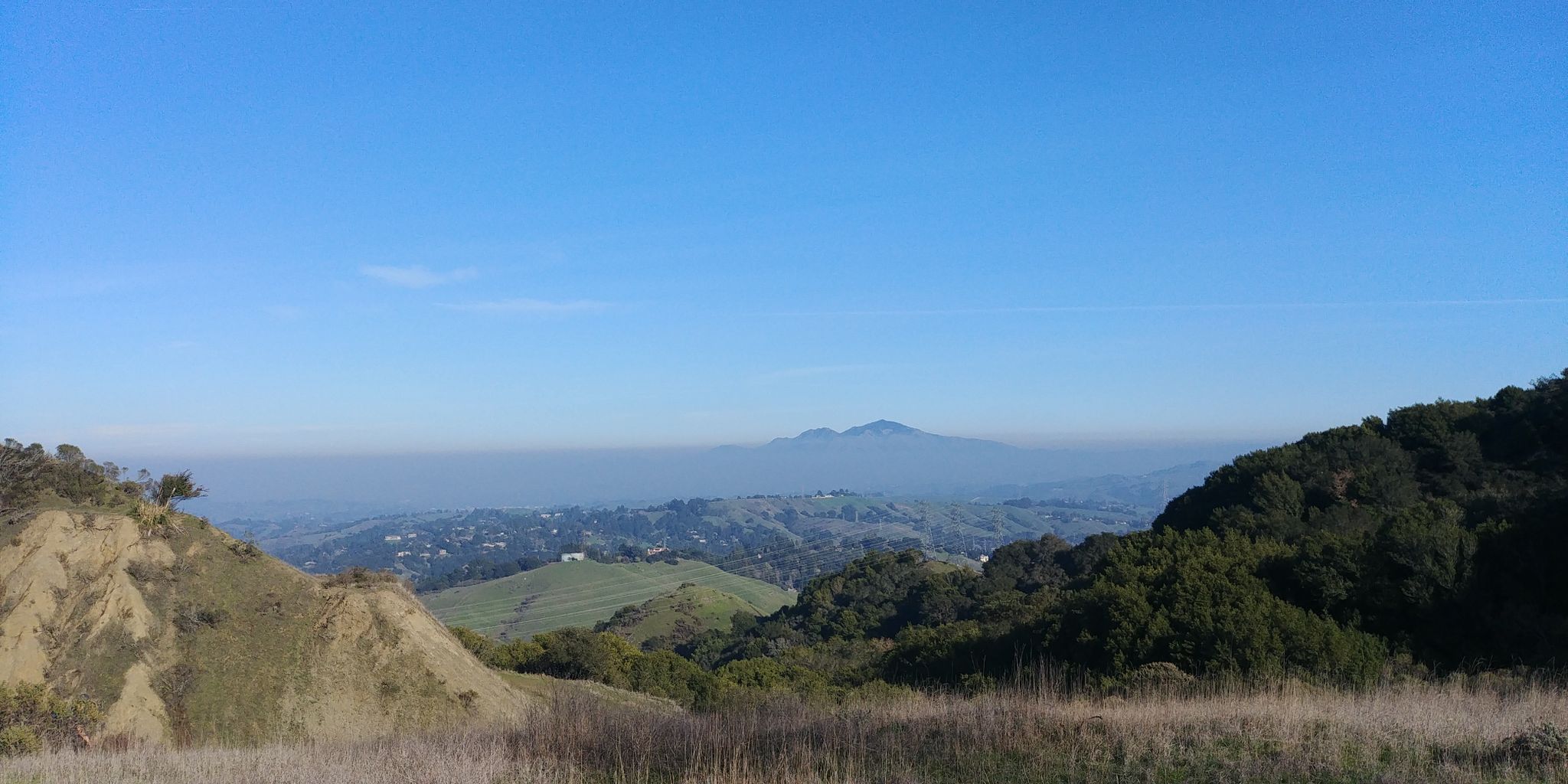 Expansive view of green and brown hills under a clear blue sky. - Mazzariello Labyrinth via Wilder Road
