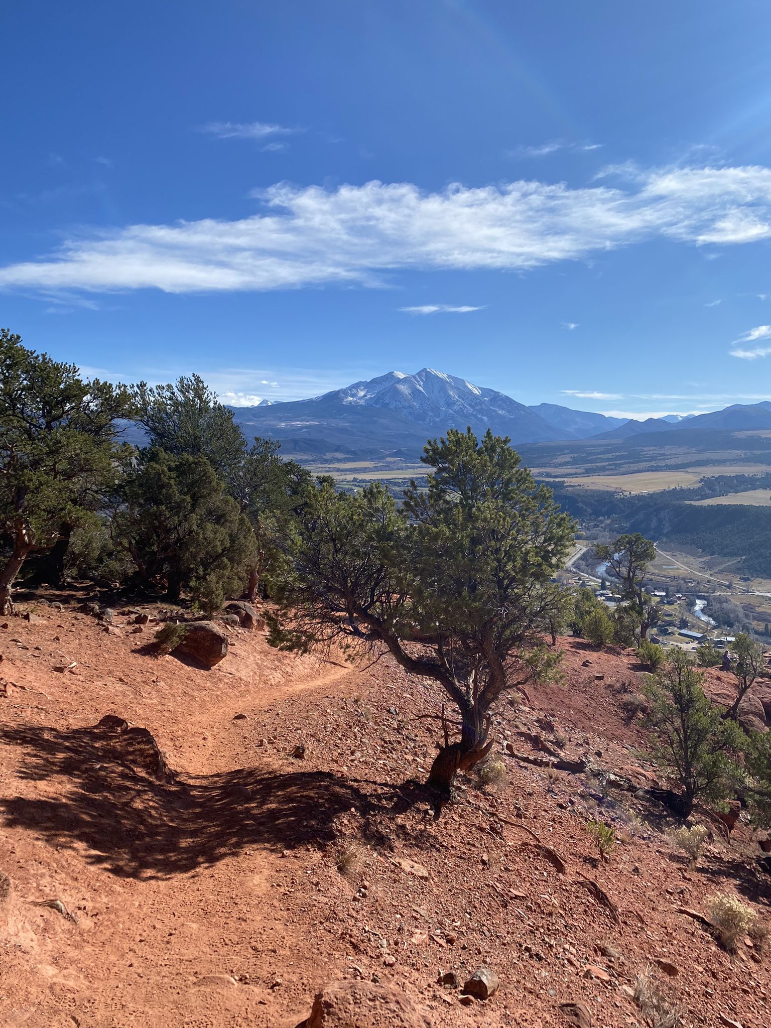 Scenic mountain view from a red dirt trail under a blue sky. - Red Hill & Elk Traverse loop