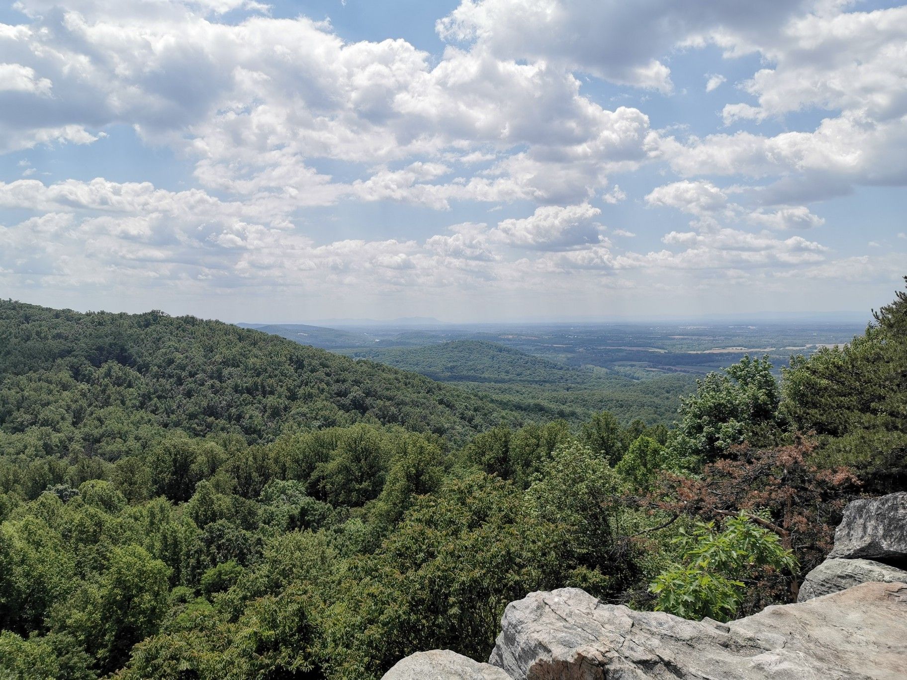 Forested mountain landscape with a distant valley under a partly cloudy sky. - Raven Rocks via Appalachian Trail