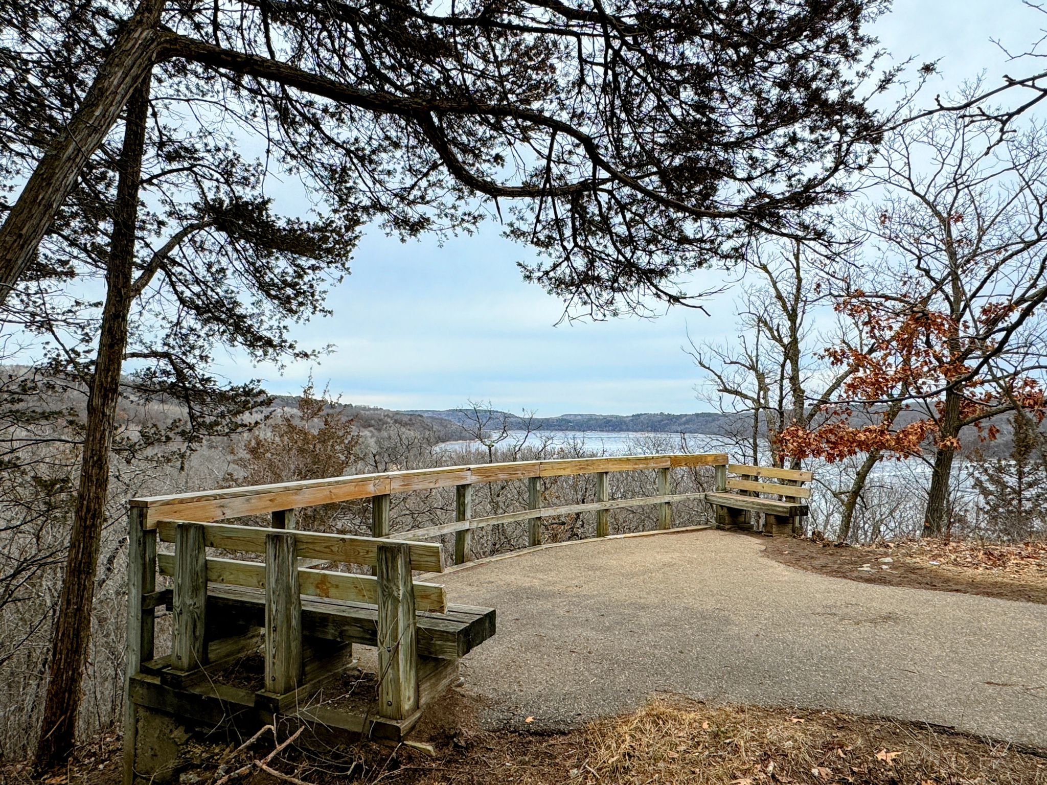 A wooden observation deck with benches overlooks a large lake and bare trees. - Saint Croix River Viewpoint – Visitor Center loop from Afton State Park