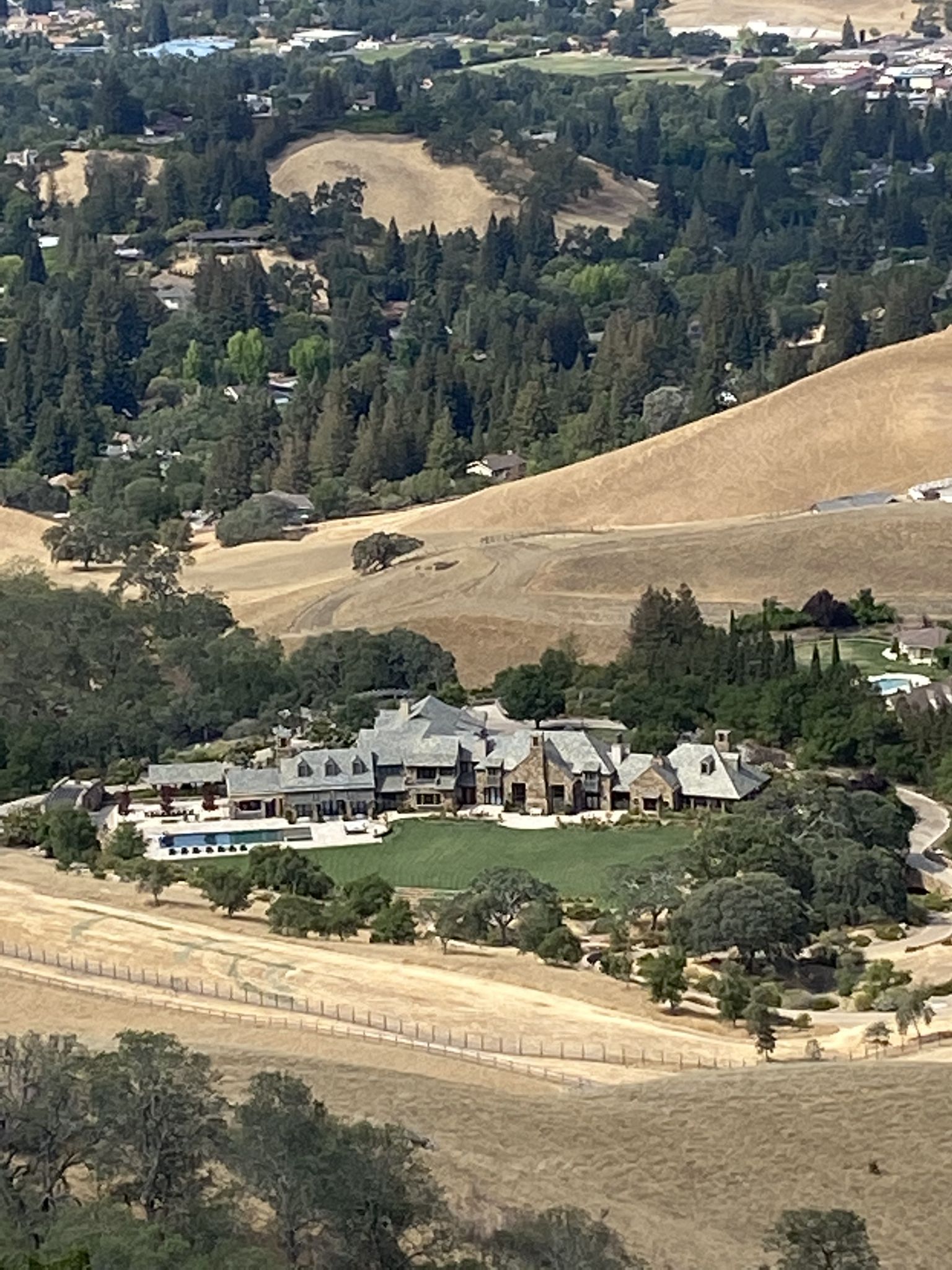 Large estate with a pool nestled among golden hills and green trees. - Wall Point – Wall Pt. Road loop from Alamo