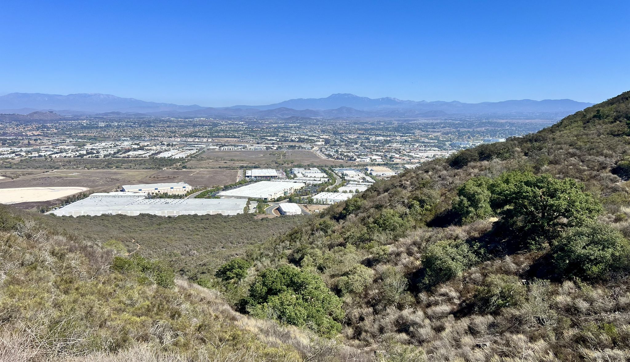 Panoramic view of a valley city and distant mountains on a clear day. - Temecula lookout and Murrieta Creek Bike Trail loop