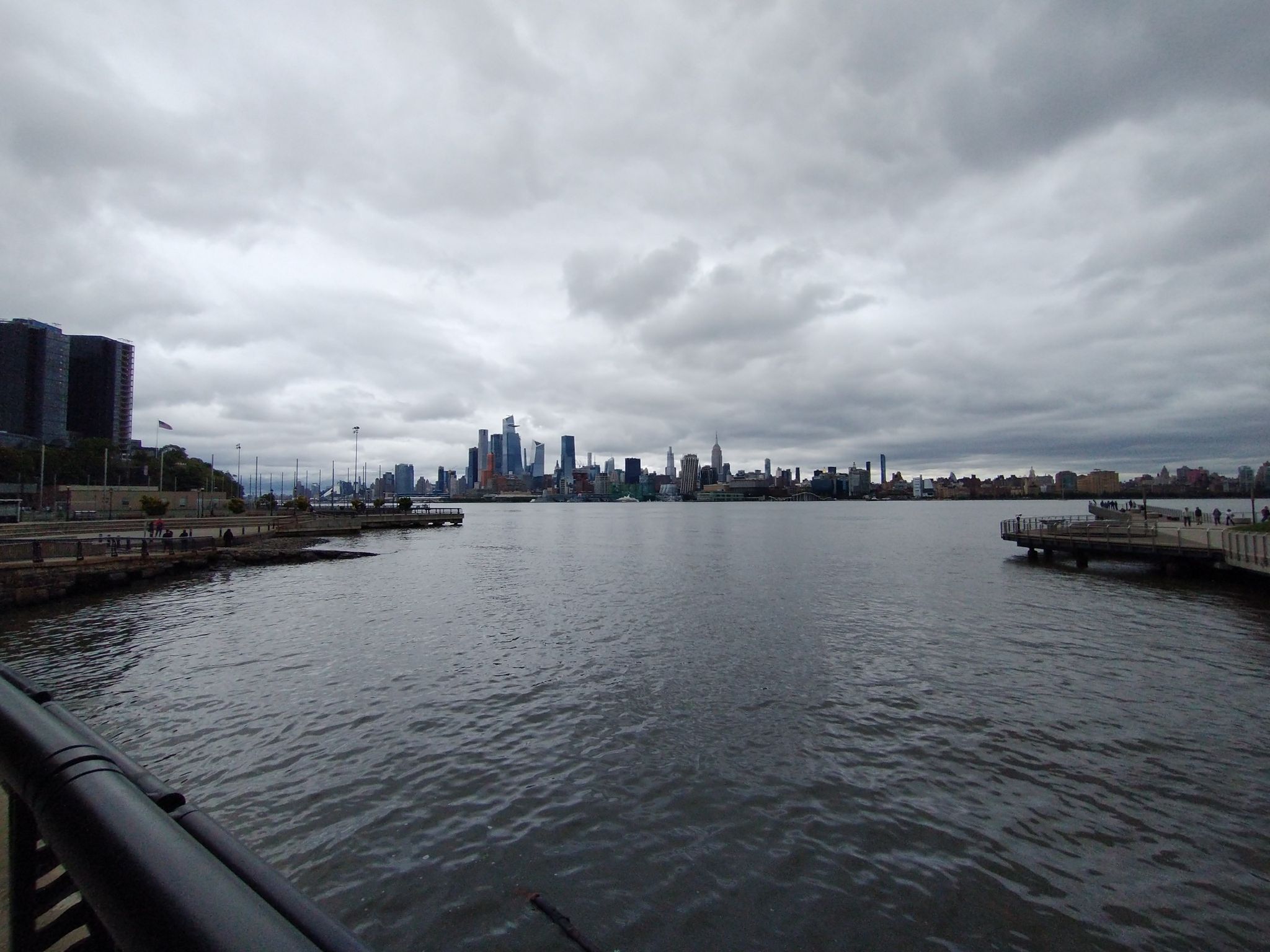 Distant city skyline across wide water under a gray, overcast sky. - Washington Park – West Hoboken Bike Path loop from 2nd Street