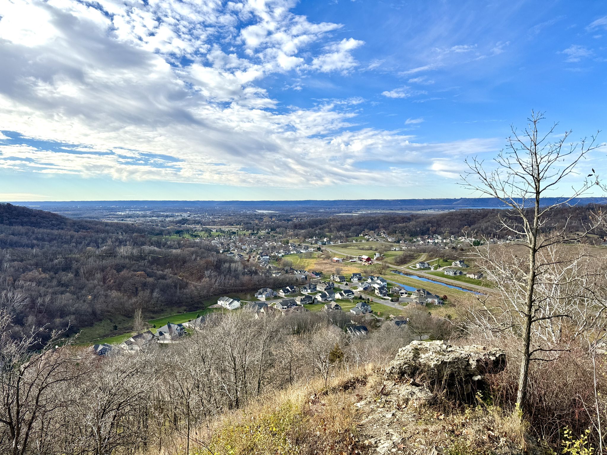 Panoramic view of a valley town under a bright, cloudy sky. - Loggers Loop Trail