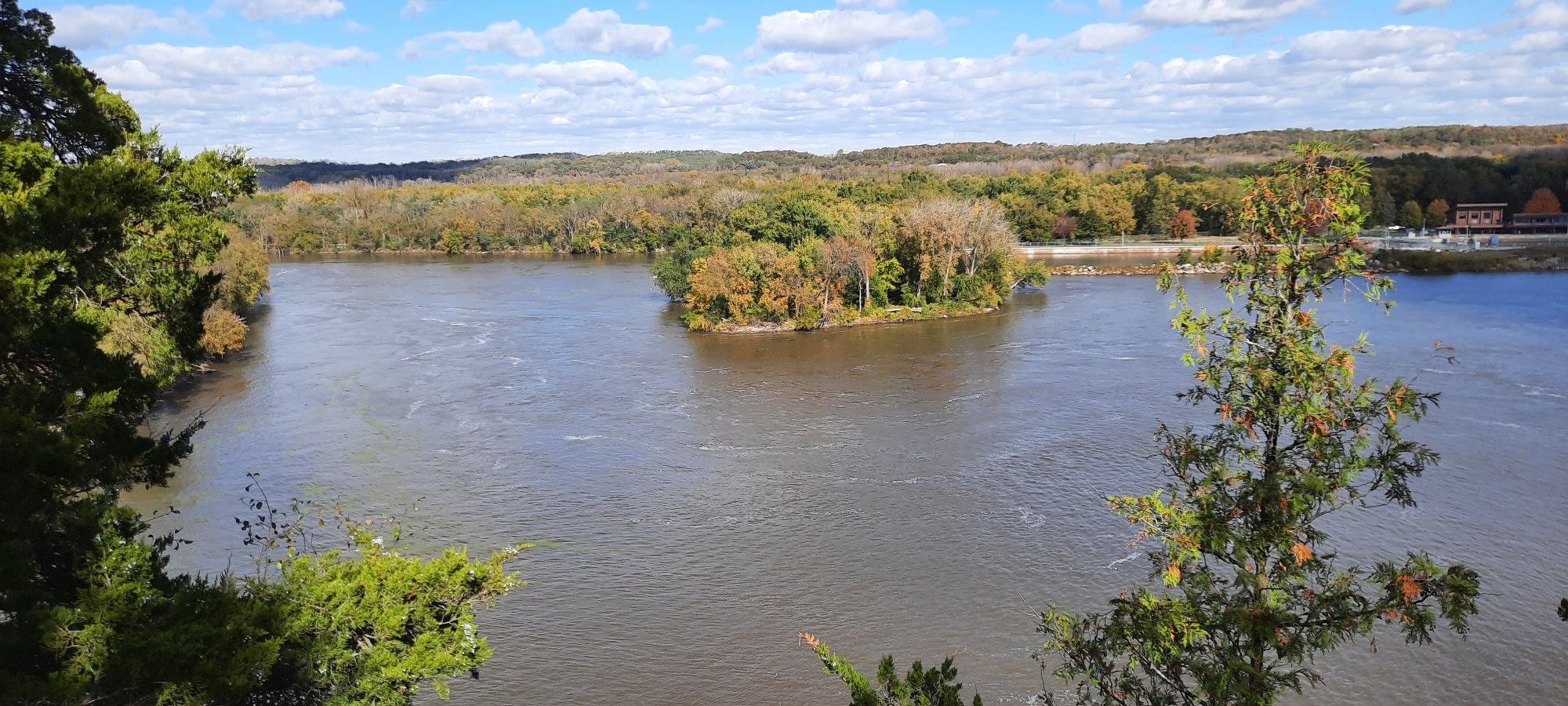 A wide river with an island, surrounded by autumn trees under a blue sky. - Starved Rock, Wildcat Canyon, and French Canyon Loop