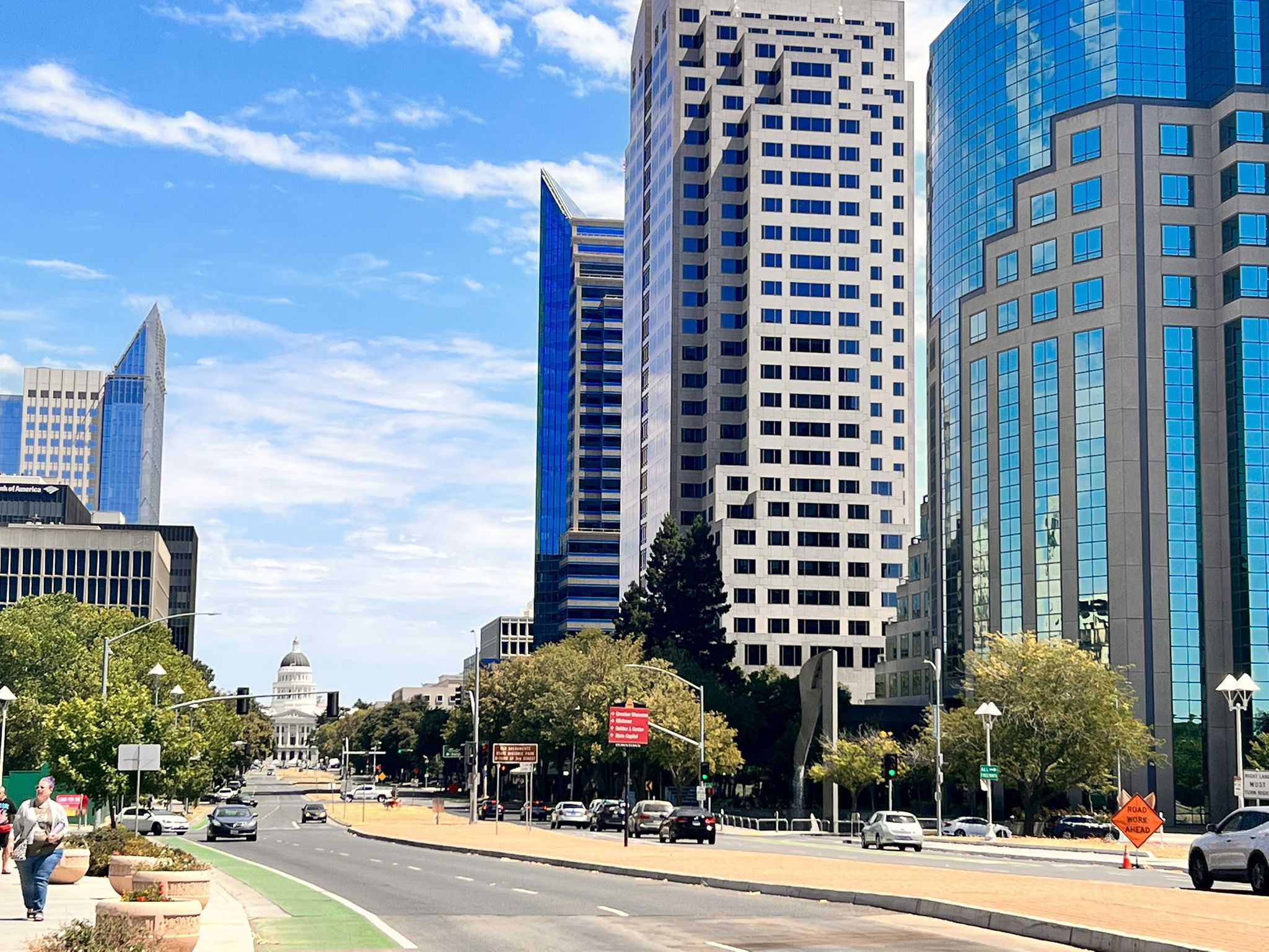 A bustling city street with tall buildings and people walking on a sunny day. - Tower Bridge loop from Sacramento