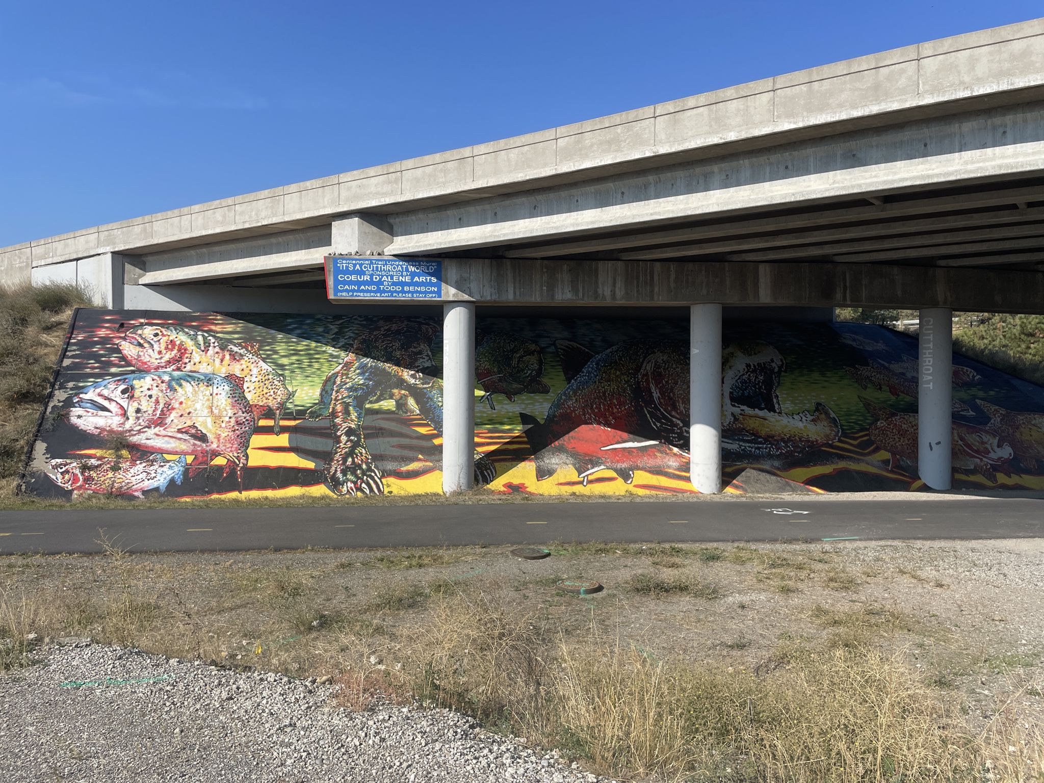 Colorful mural depicting wildlife under a concrete bridge over a path. - Graffiti Street Art loop from Prairie & Courcelles