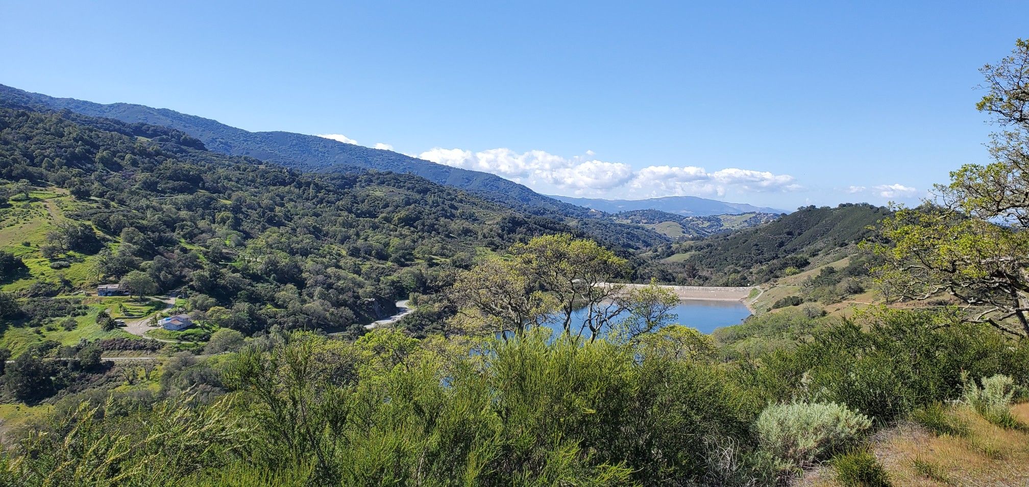 Scenic view of a blue reservoir surrounded by lush green hills under a clear sky. - Mine Hill Trailhead – Mine Hill Trail loop from Mockingbird Hill Entrance