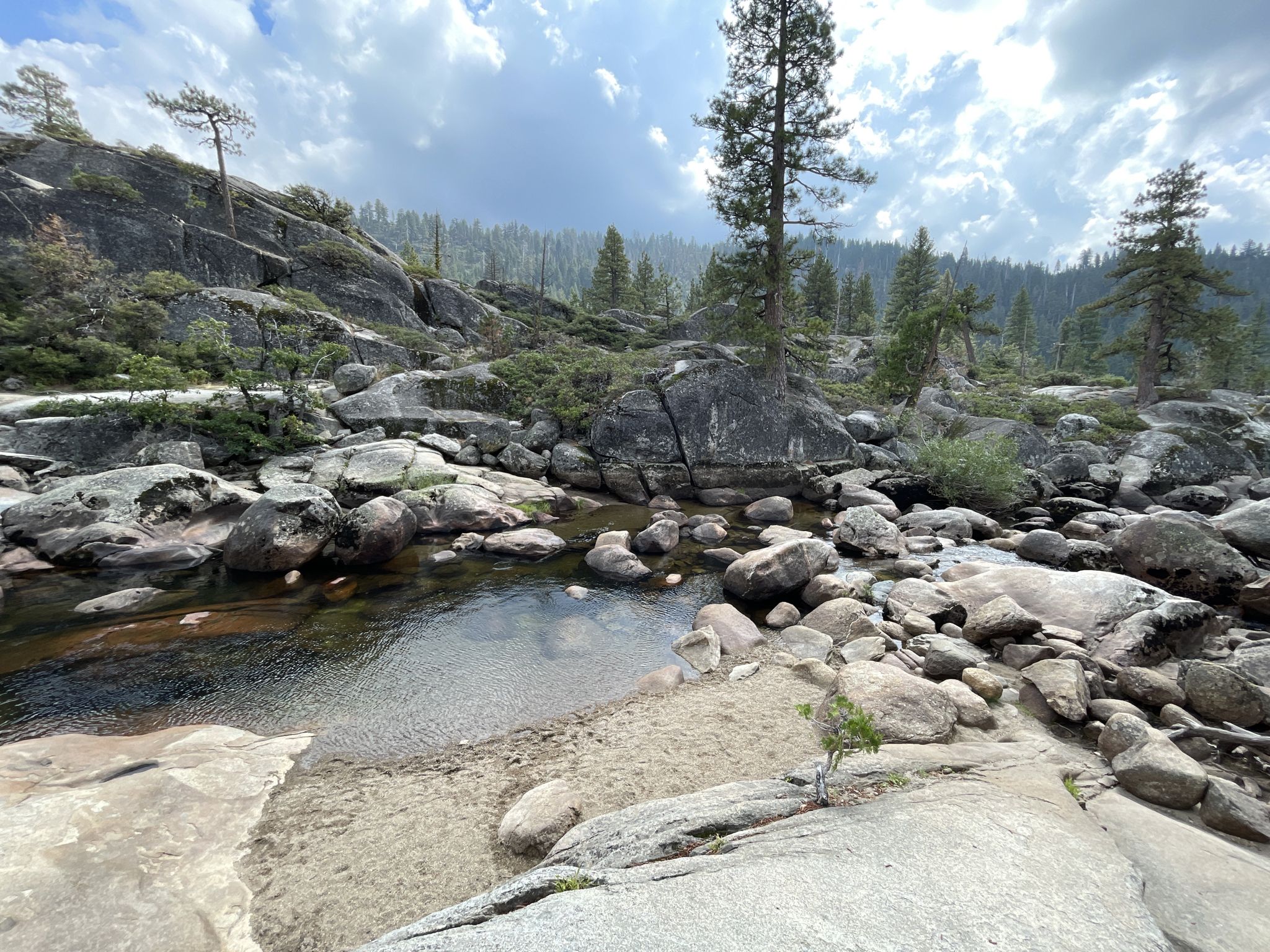 Rocky stream bed with small pools of water under a cloudy sky. - Pinecrest Lake and Pinecrest Peak Loop