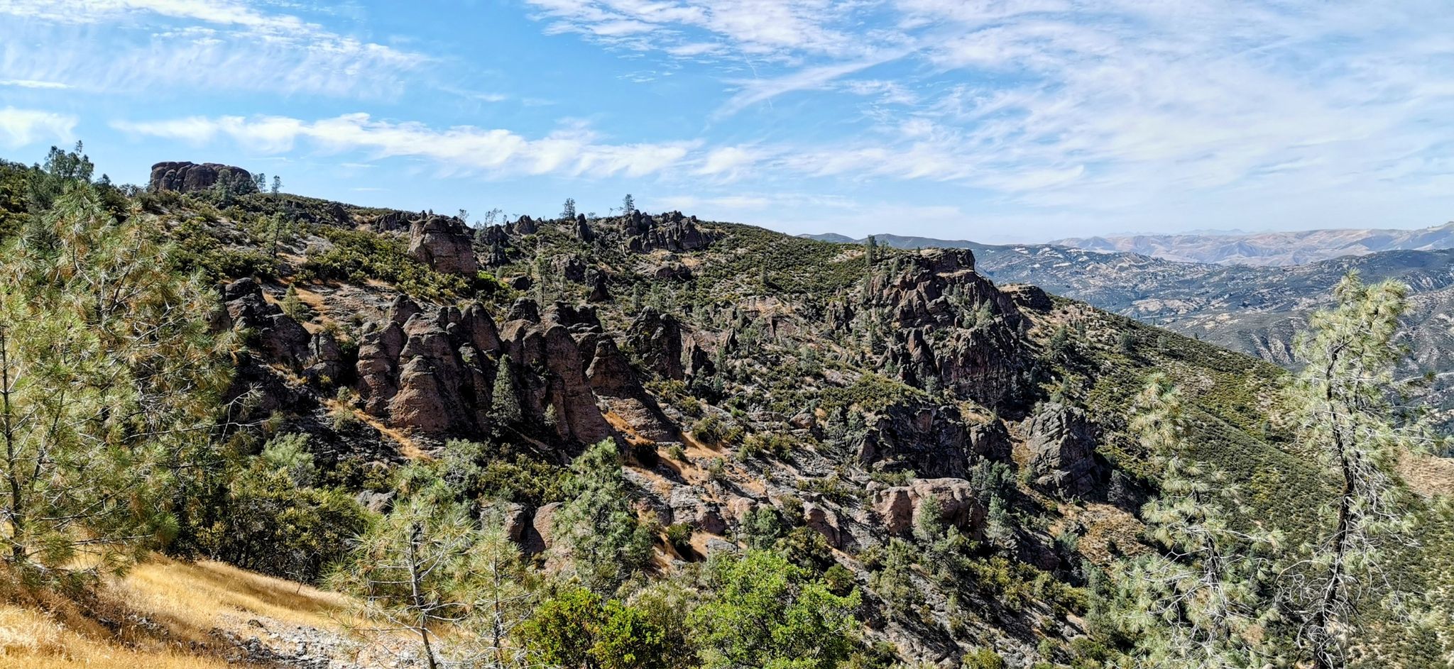 Rocky, craggy hillsides covered in sparse green vegetation under a blue sky. - Bench Trail – Southern Section – Condor Gulch Trail loop from Bear Valley