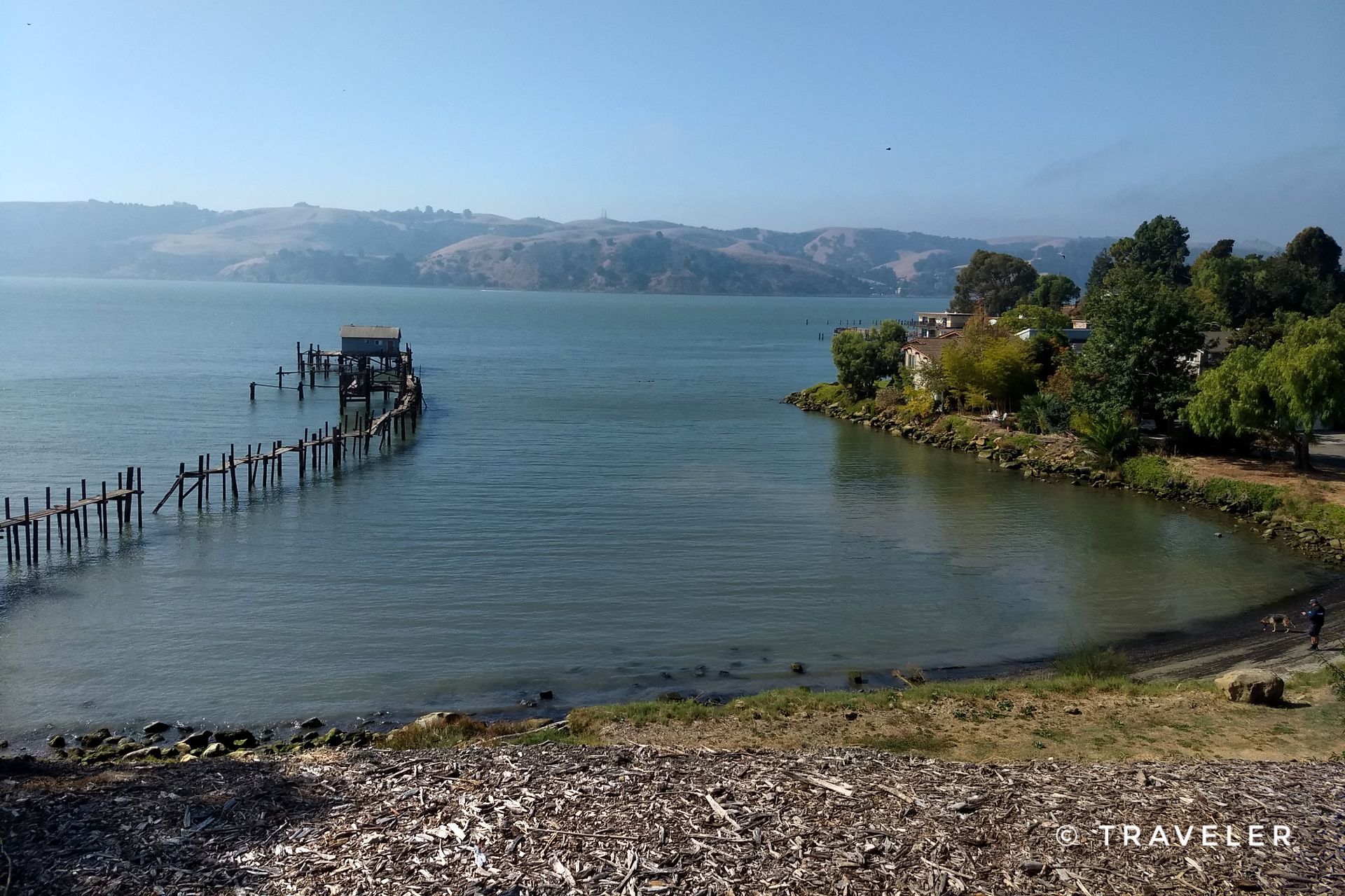 Calm water with a long wooden pier and distant hills under a clear sky. - San Francisco Bay Trail: Benicia Waterfront