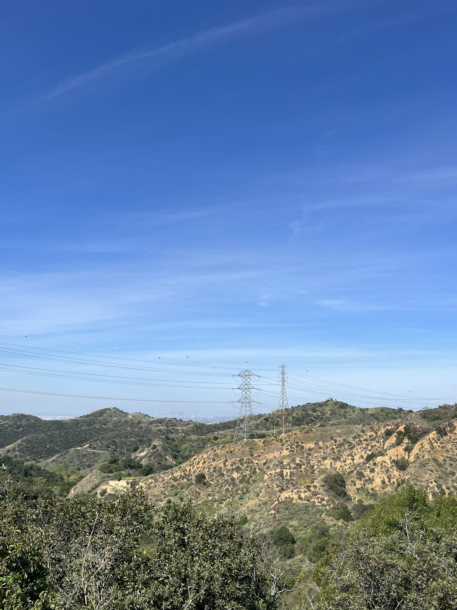 Power lines stretch across dry, rolling hills under a clear blue sky. - Workman Hill and Schabarum-Skyline Loop