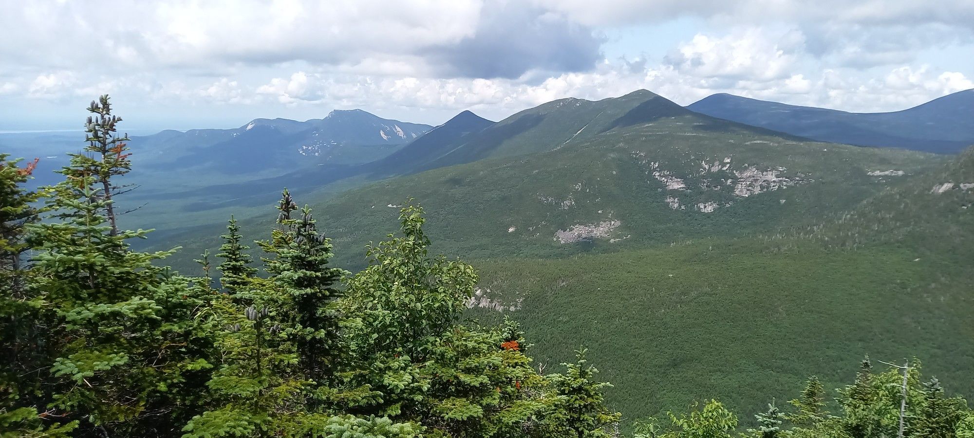 Panoramic view of green forested mountains under a cloudy sky. - Baxter Peak via Abol, Saddle, and Hunt Trail Loop