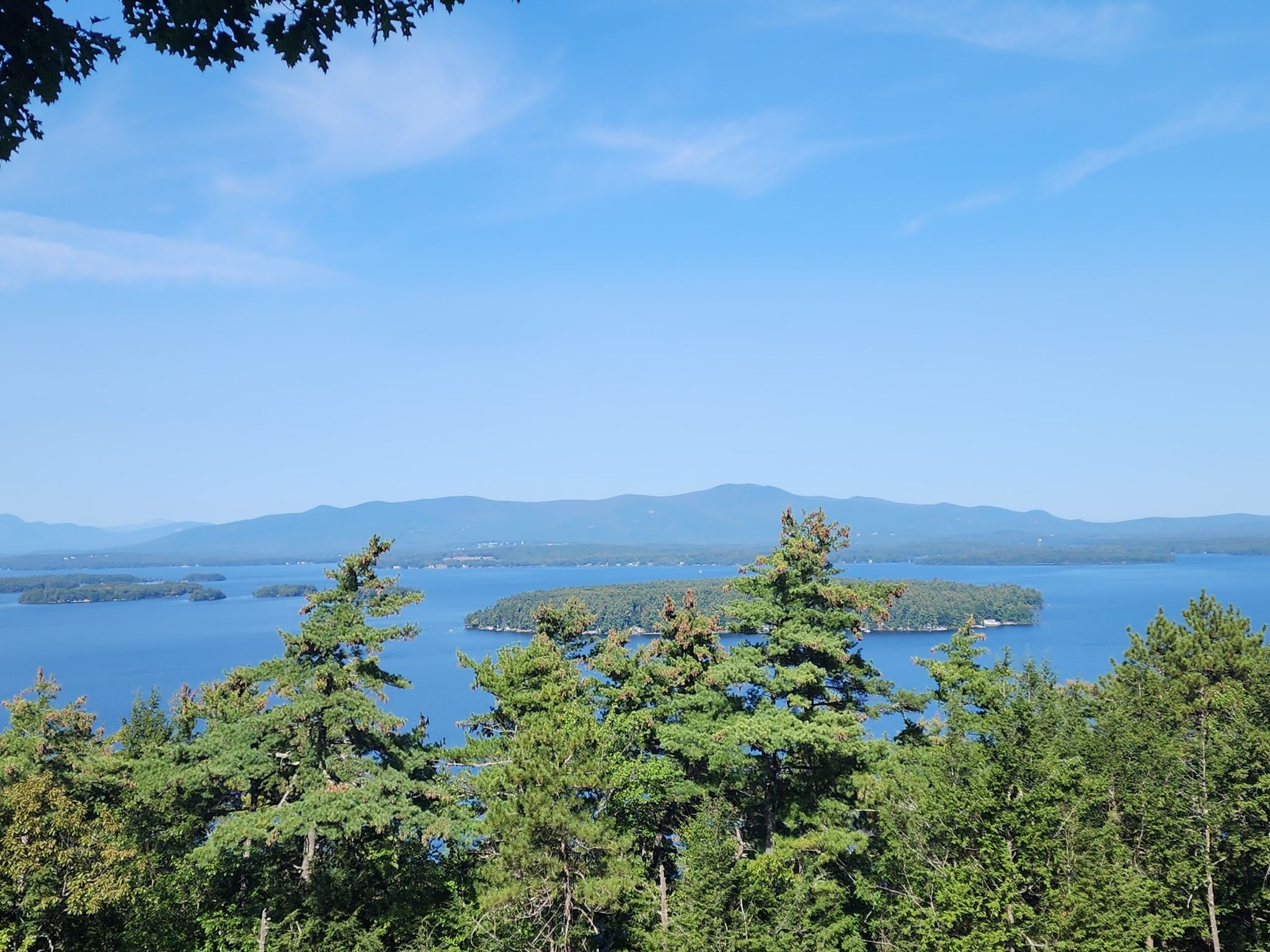 Panoramic view of a large lake with islands and distant mountains. - Lockes Hill Loop via Quarry and Lakeview Trails