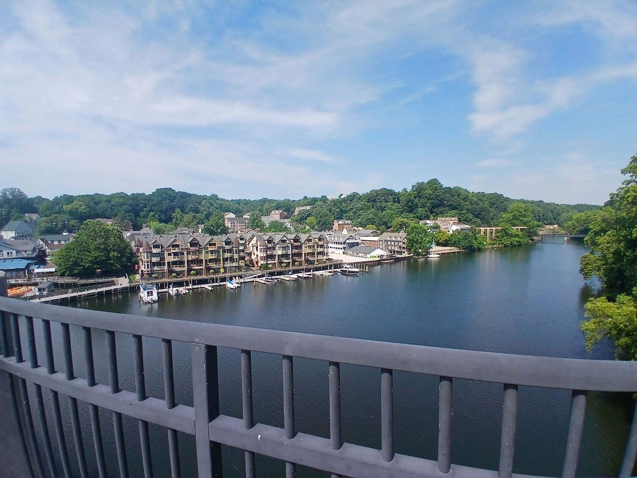 View from a bridge of a river with buildings and boats on a sunny day. - Chapel Road scenic views – Chinn Park loop from Dale City