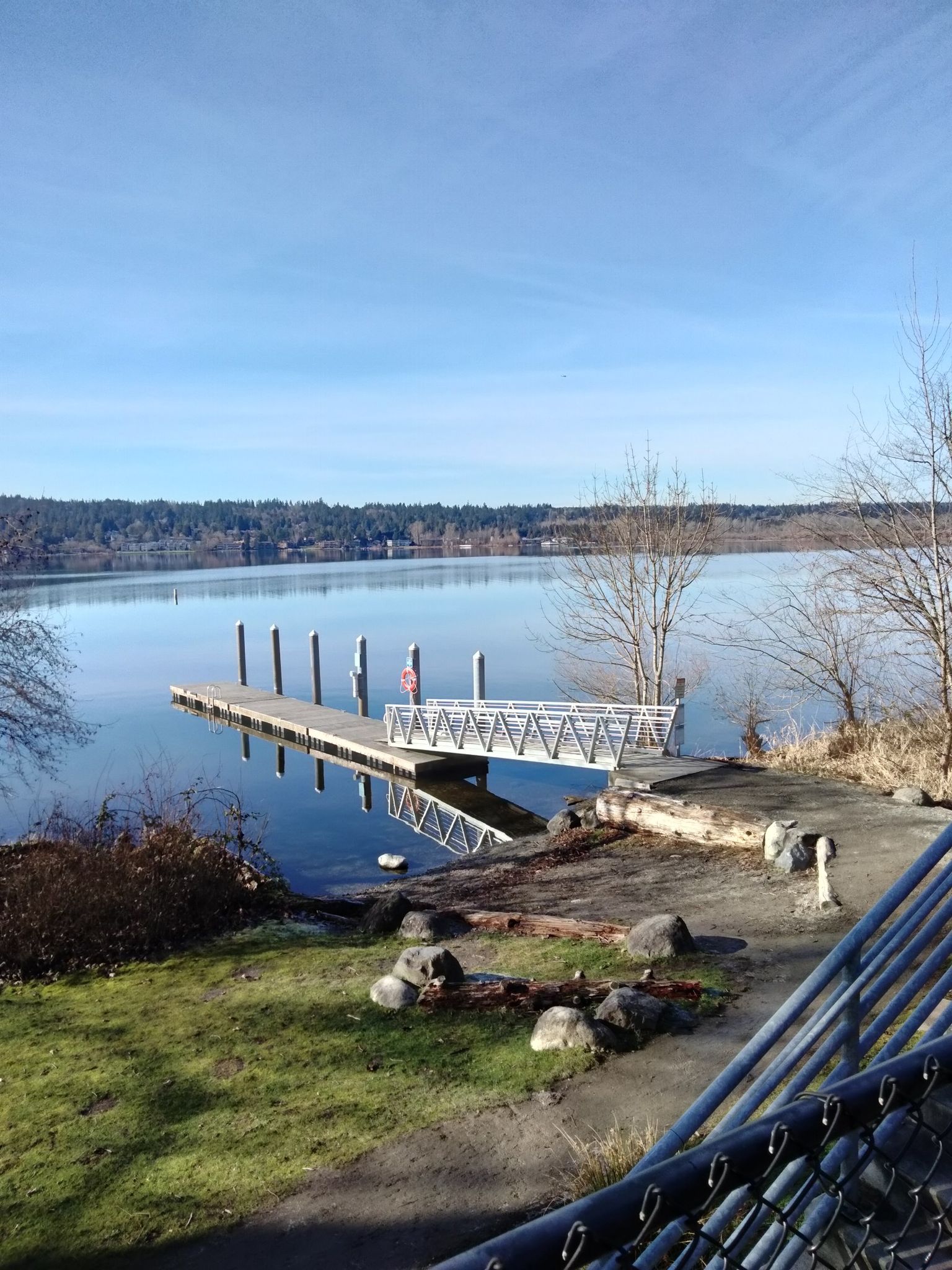 Sunny day over a calm lake with a long wooden dock and clear blue sky. - Jerry Baker Memorial Velodrome – Marymoor Connector loop from Redmond