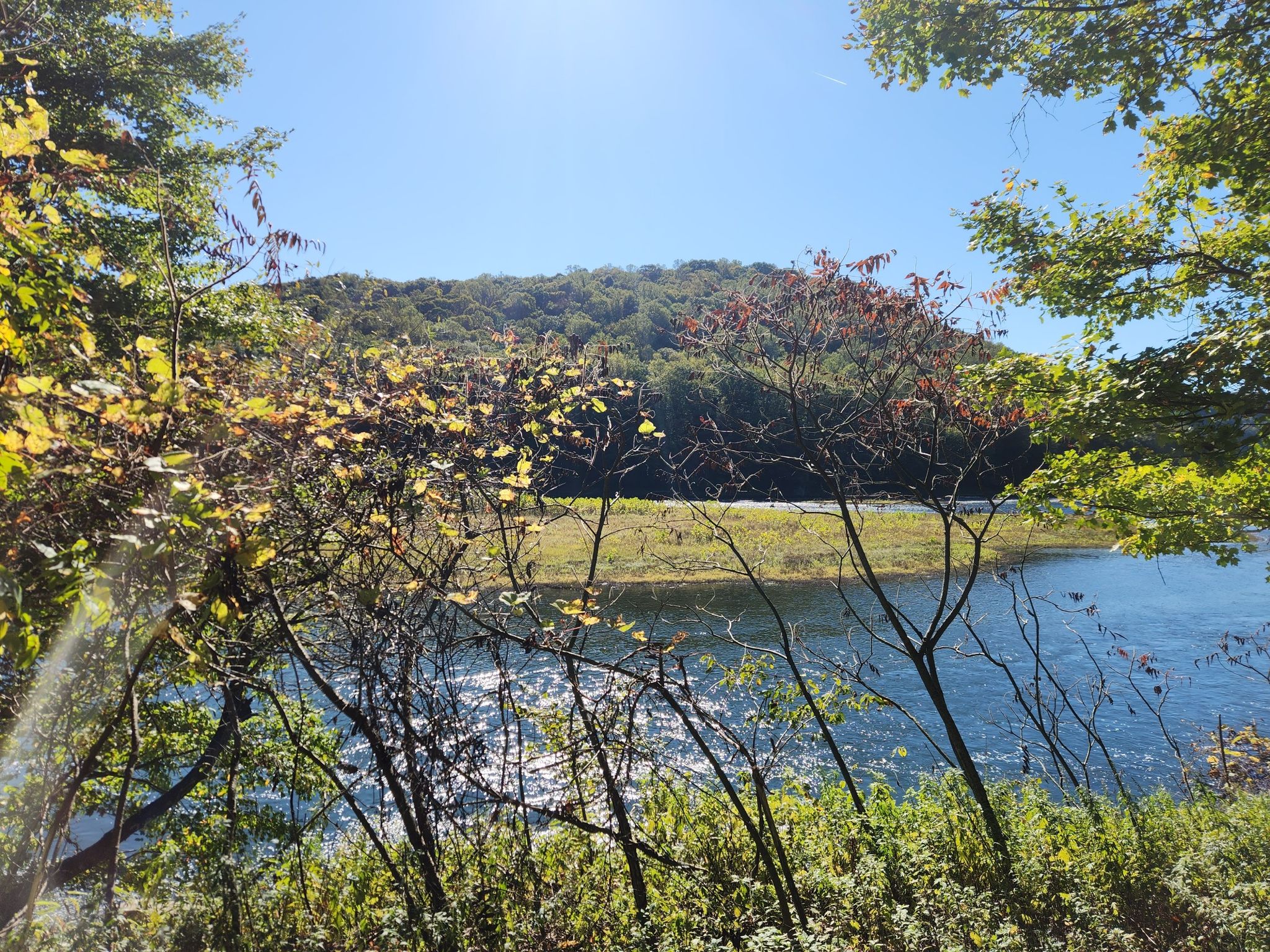 Sunny view of a river, distant wooded hill, and autumn foliage. - Indian God Rock – Rockland Furnace loop from Cranberry Township