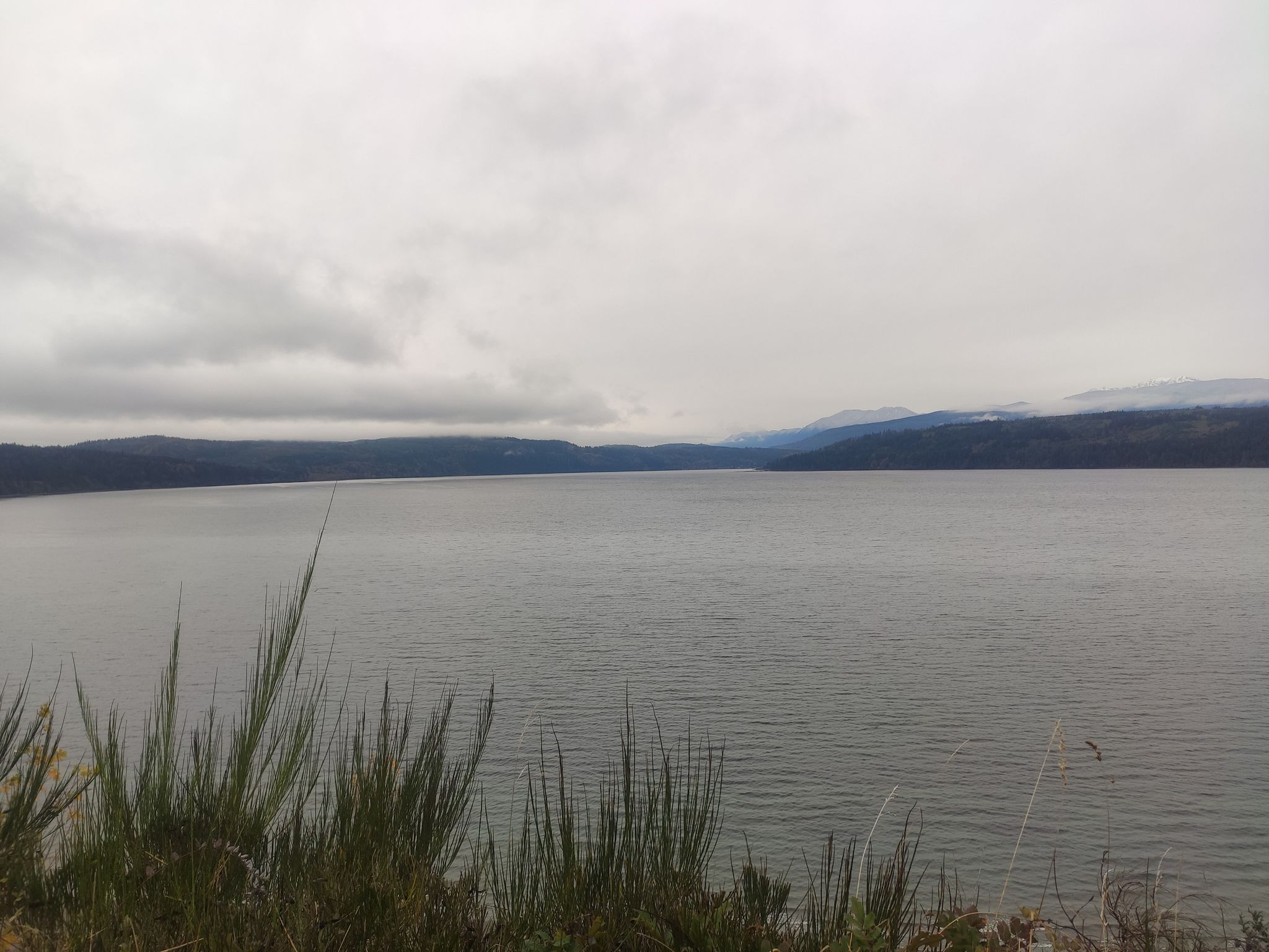 Vast grey lake under an overcast sky, with distant hills. - Port Townsend loop