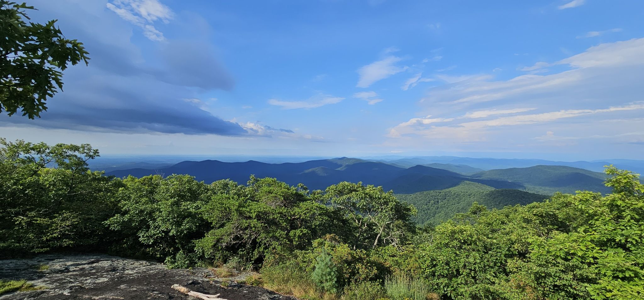 Mountain vista with lush green trees under a partly cloudy blue sky. - Blood Mountain Loop via Slaughter Creek Trail