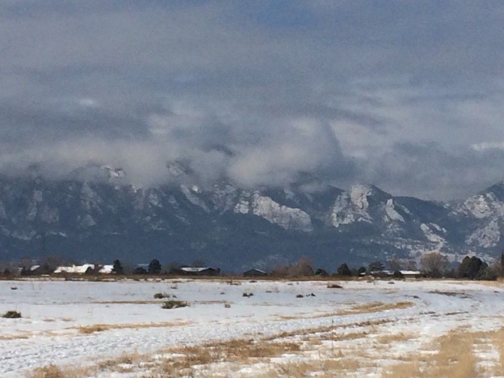 Snow-covered field with distant mountains partially obscured by clouds. - Davidson Mesa Trail – Davidson Mesa loop from Paragon Estates