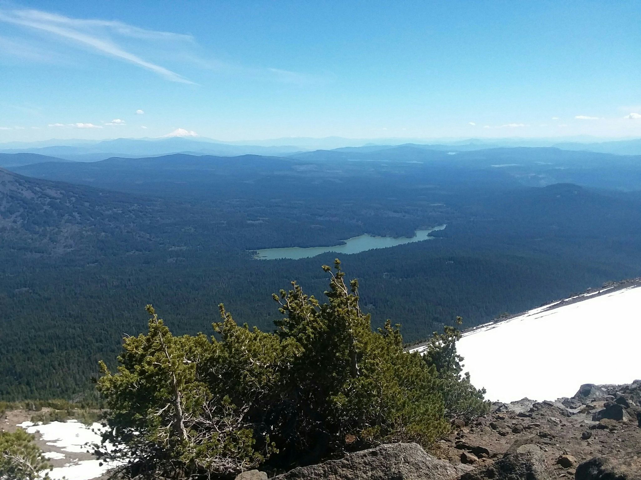 Mountain vista with a lake, forest, and snow patches under a clear sky. - Mount McLoughlin – Junction to Frey Lake loop from Mt. McLoughlin Trailhead