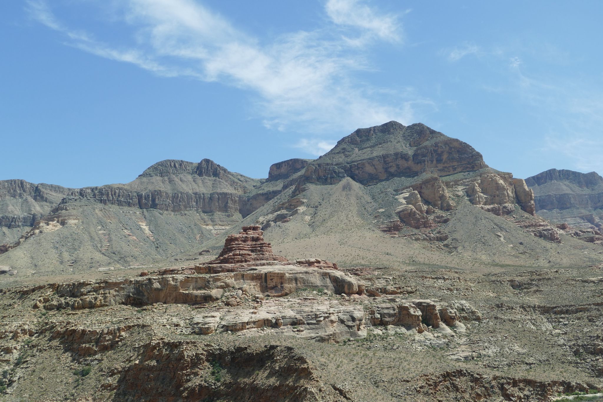 Vast desert landscape with layered mountains and a prominent red rock formation. - View to South Mountain – Majestic View Lodge loop from Springdale