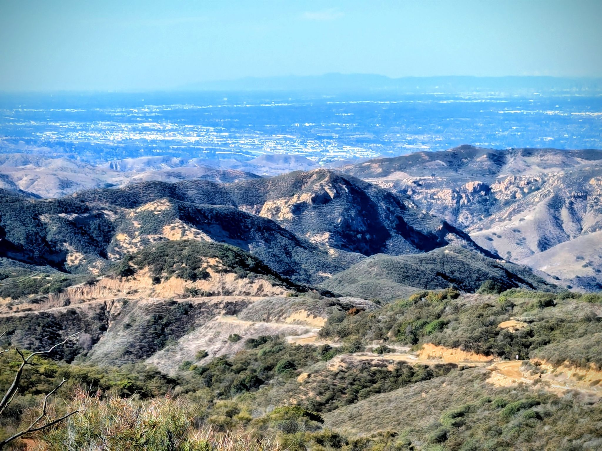 Panoramic view of dry, rugged mountains with a distant city under clear skies. - Black Star Falls – Beeks Place loop from Santiago Canyon College