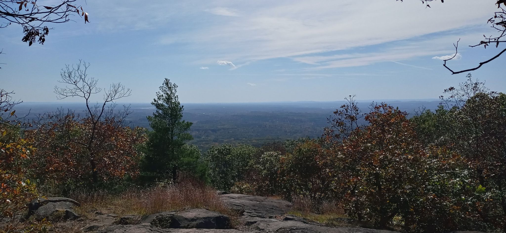 Panoramic view from a rocky mountain overlook with autumn trees under a blue sky. - Bare-Hitchcock loop