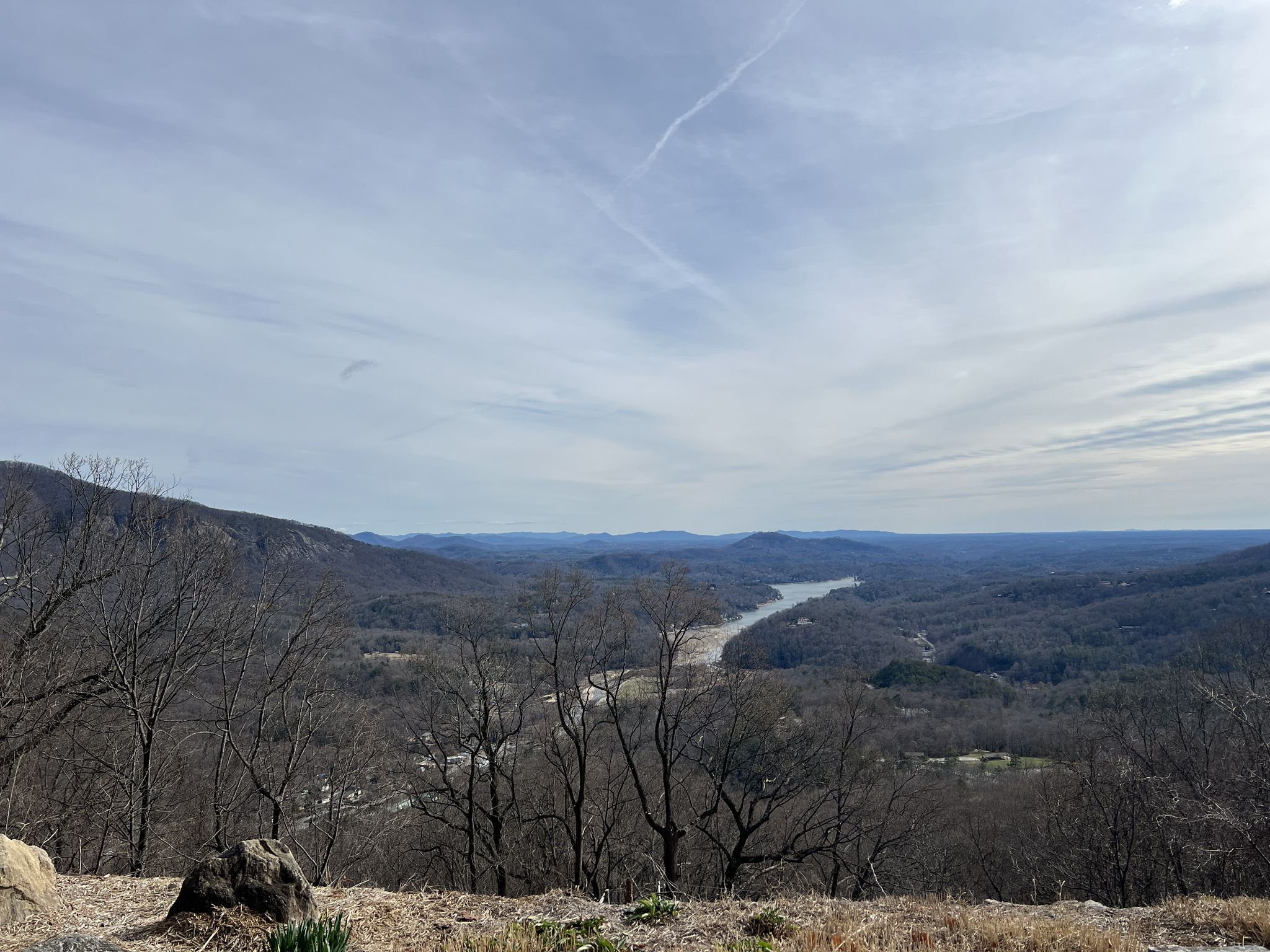 Panoramic view of a river winding through a valley with distant mountains. - Hickory Nut Falls Trail