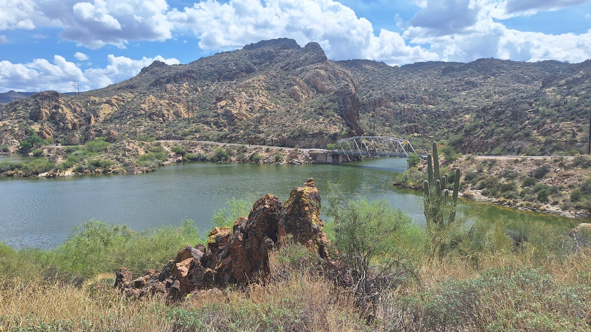 A lake surrounded by desert mountains under a partly cloudy sky. - Canyon Lake & Tortilla Flat via Apache Trail