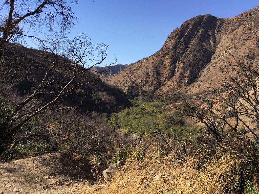 Panoramic view of a green valley nestled between dry, rugged mountains. - Santa Paula Canyon to First Falls