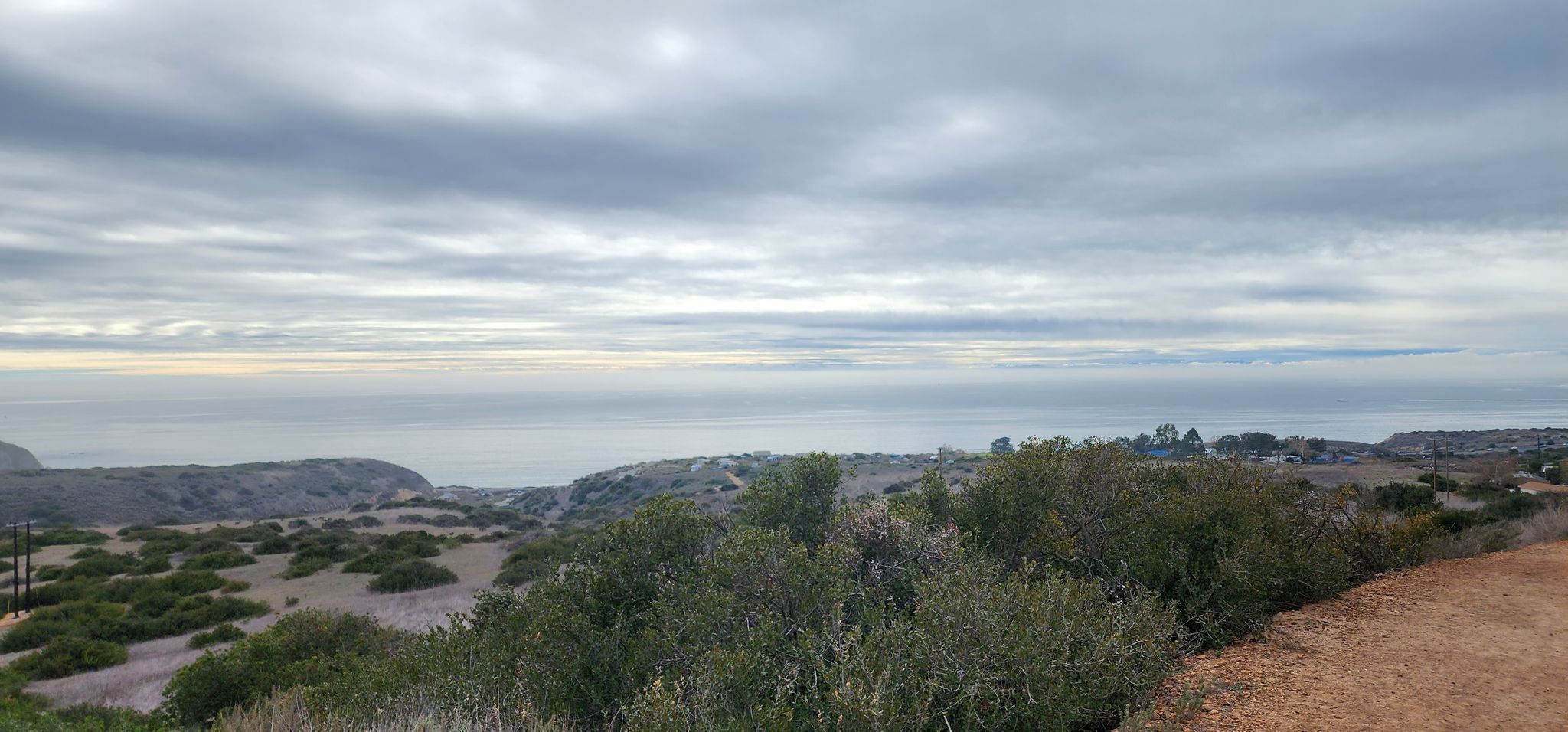 Overcast sky above a vast ocean and coastal hills with sparse vegetation. - Rattlesnake Trail – Laguna Coast Wilderness Park loop from Sage Hill School