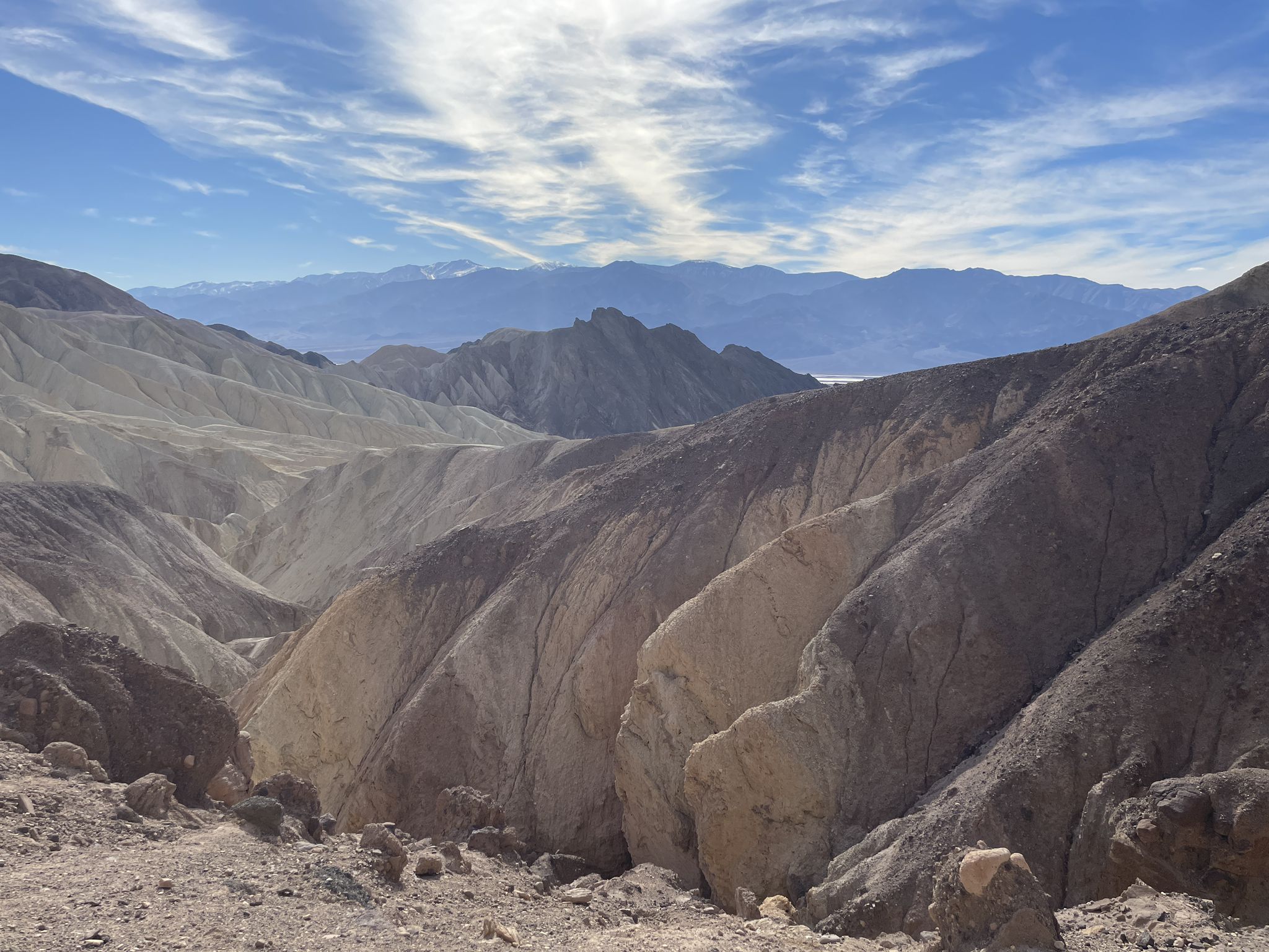 Expansive desert badlands with rolling hills and distant mountains under a bright sky. - Red Cathedral – Upper Golden Canyon Trail loop from Golden Canyon