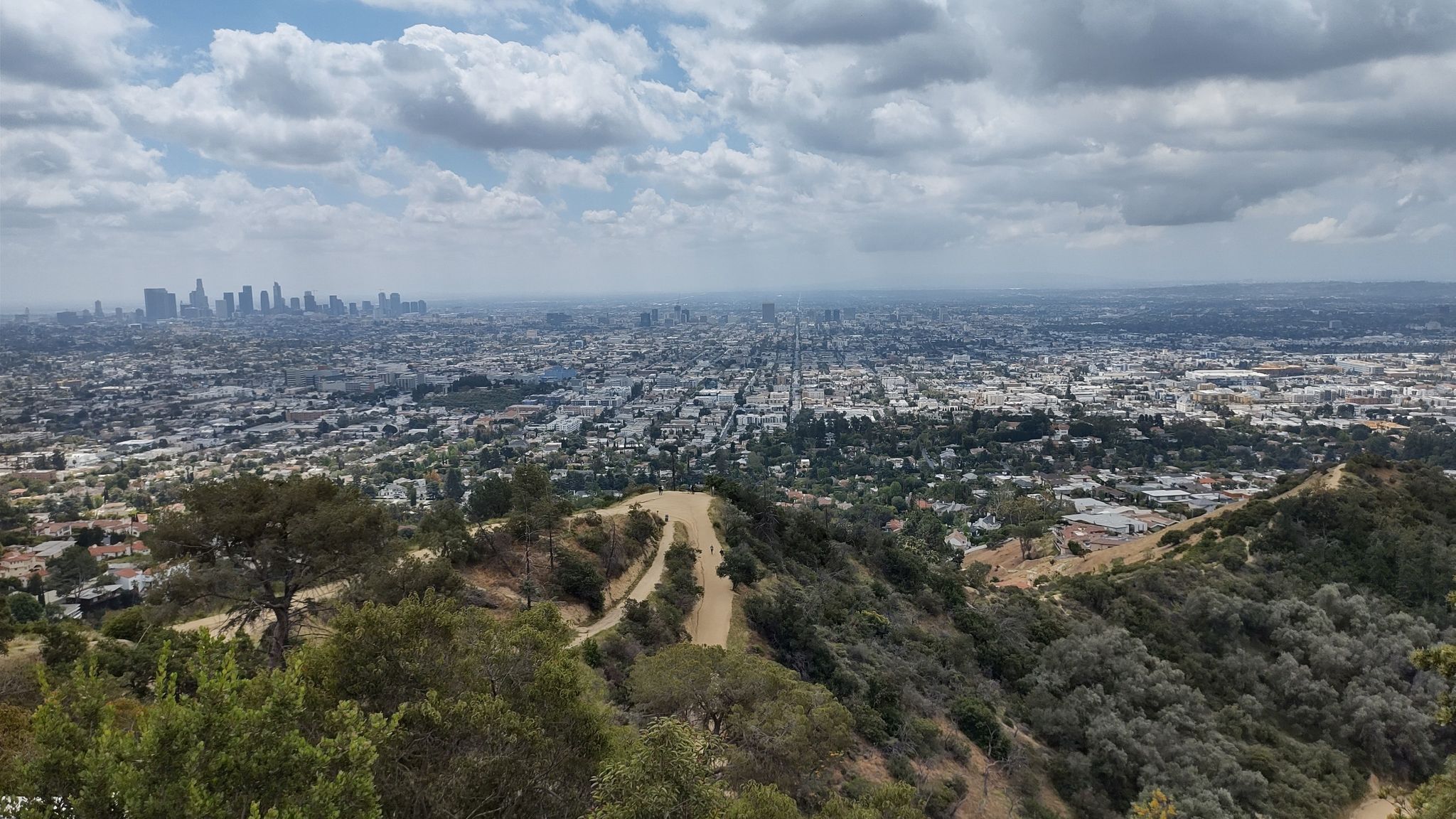 Vast city panorama from a hilltop under a cloudy, diffused sky. - Observatory Overlook – Griffith Observatory loop from Hollywood/Highland