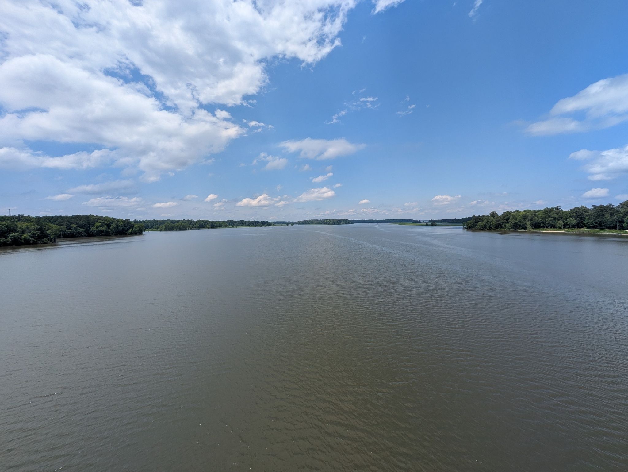 Wide river with distant tree-lined banks under a partly cloudy blue sky. - Barrett's Ferry Bridge loop from Williamsburg National Golf Club - The Jamestown Course